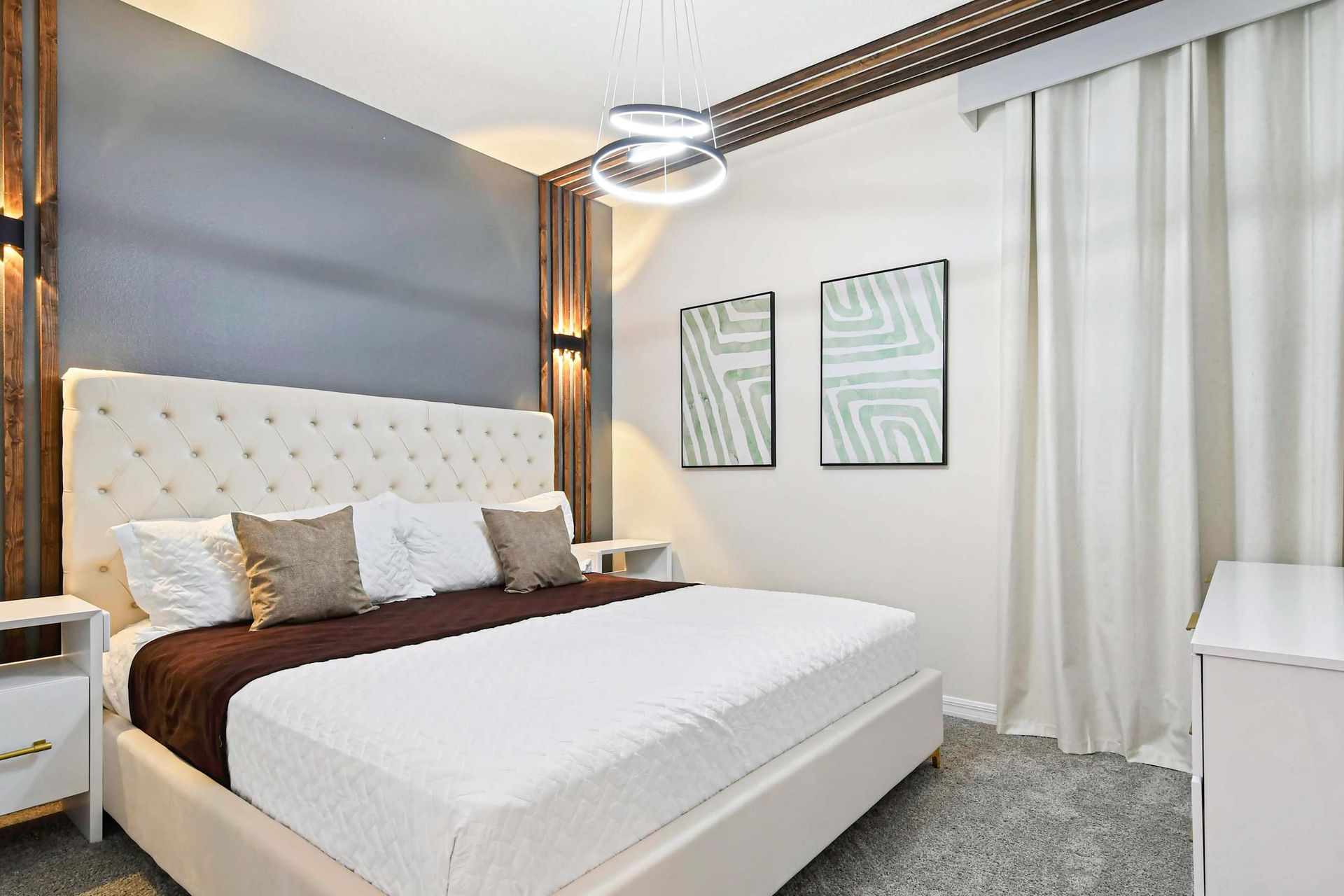 Queen-sized comfort with a TV, offering a cozy and entertainment-ready haven.