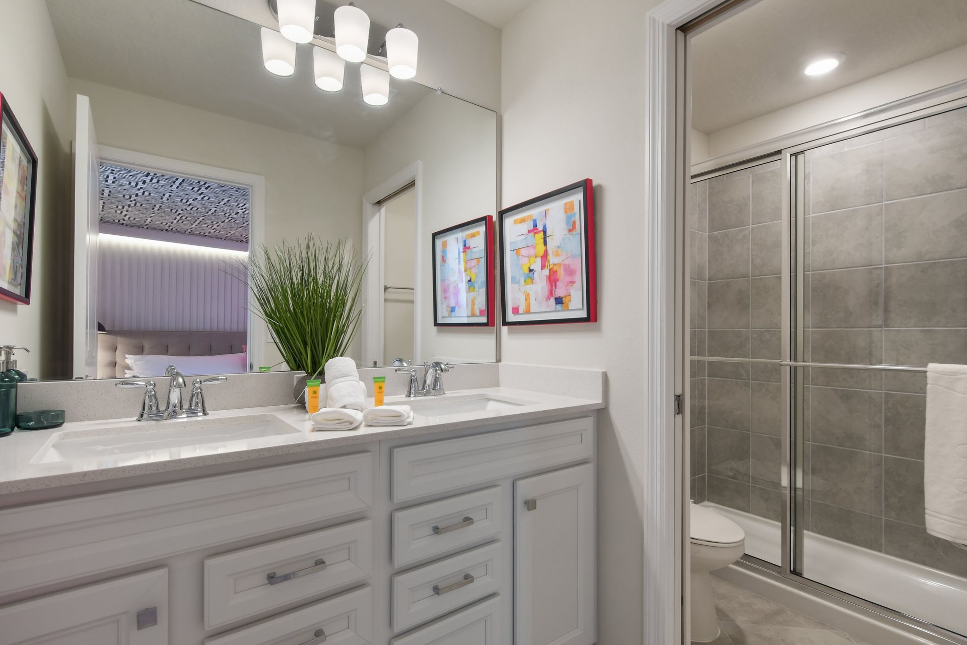 Elegant bathroom with double sinks, modern decor, and a spacious shower.