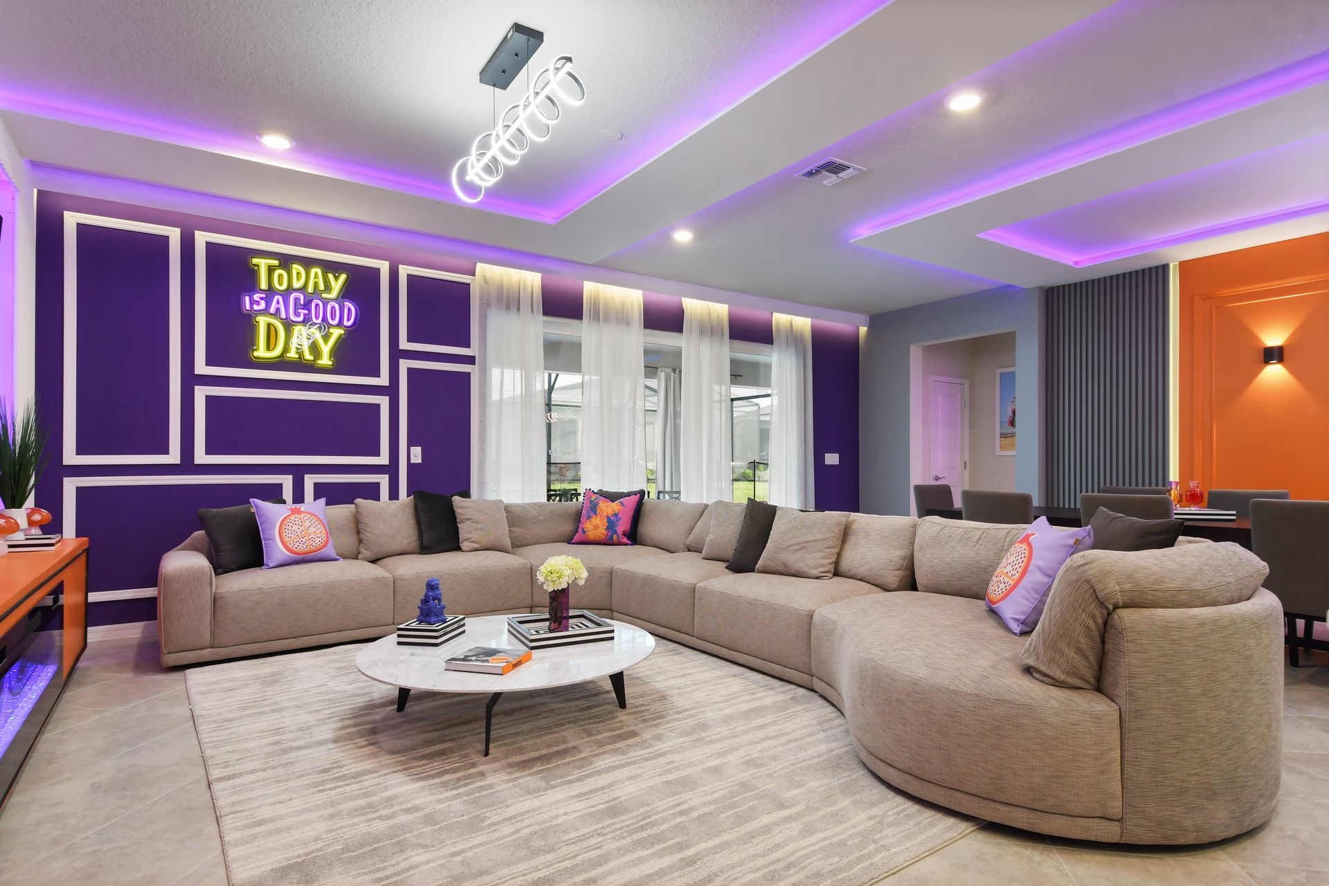 Stylish living room with cozy sectional, vibrant neon accents, and modern decor.