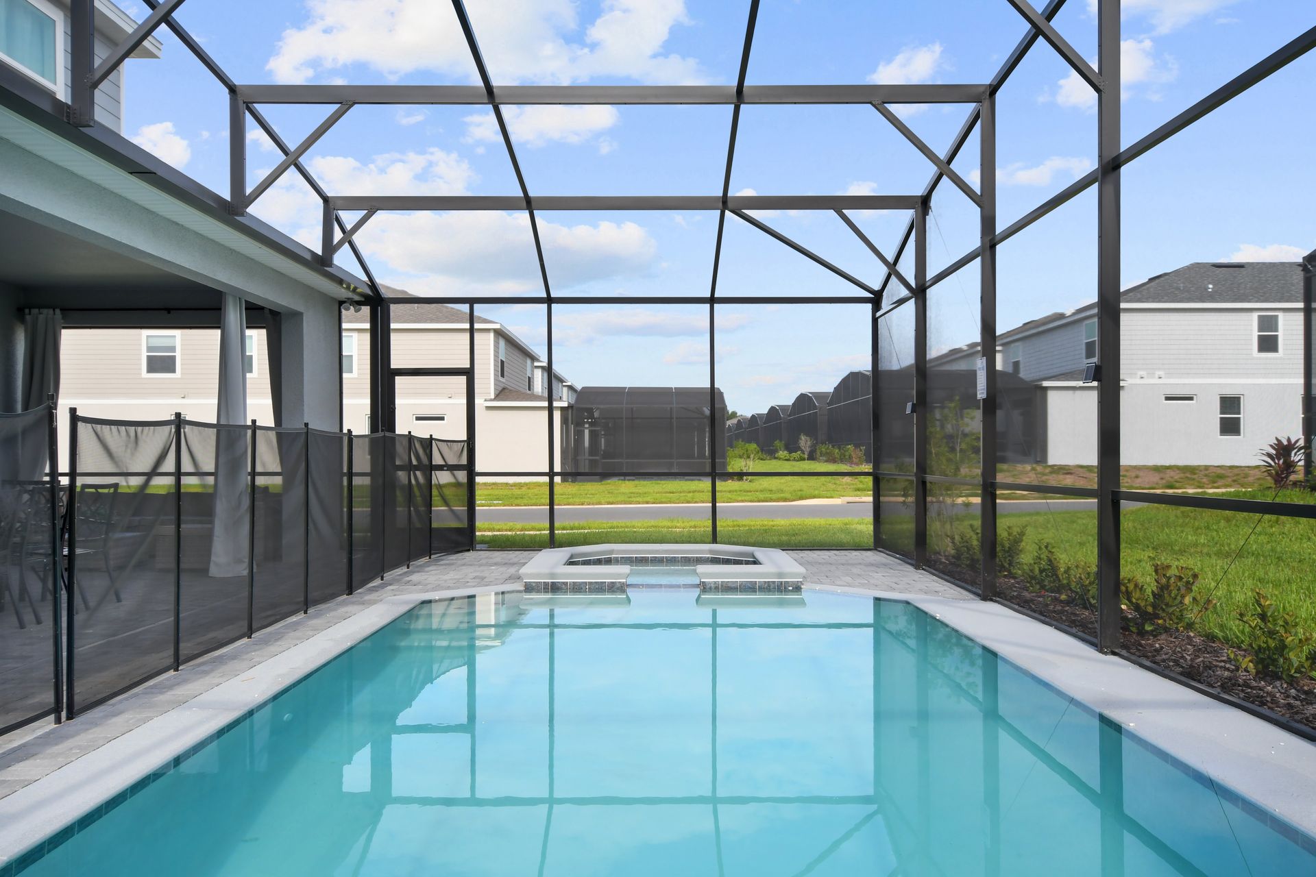 Inviting screened-in pool area with a jacuzzi, perfect for relaxation.