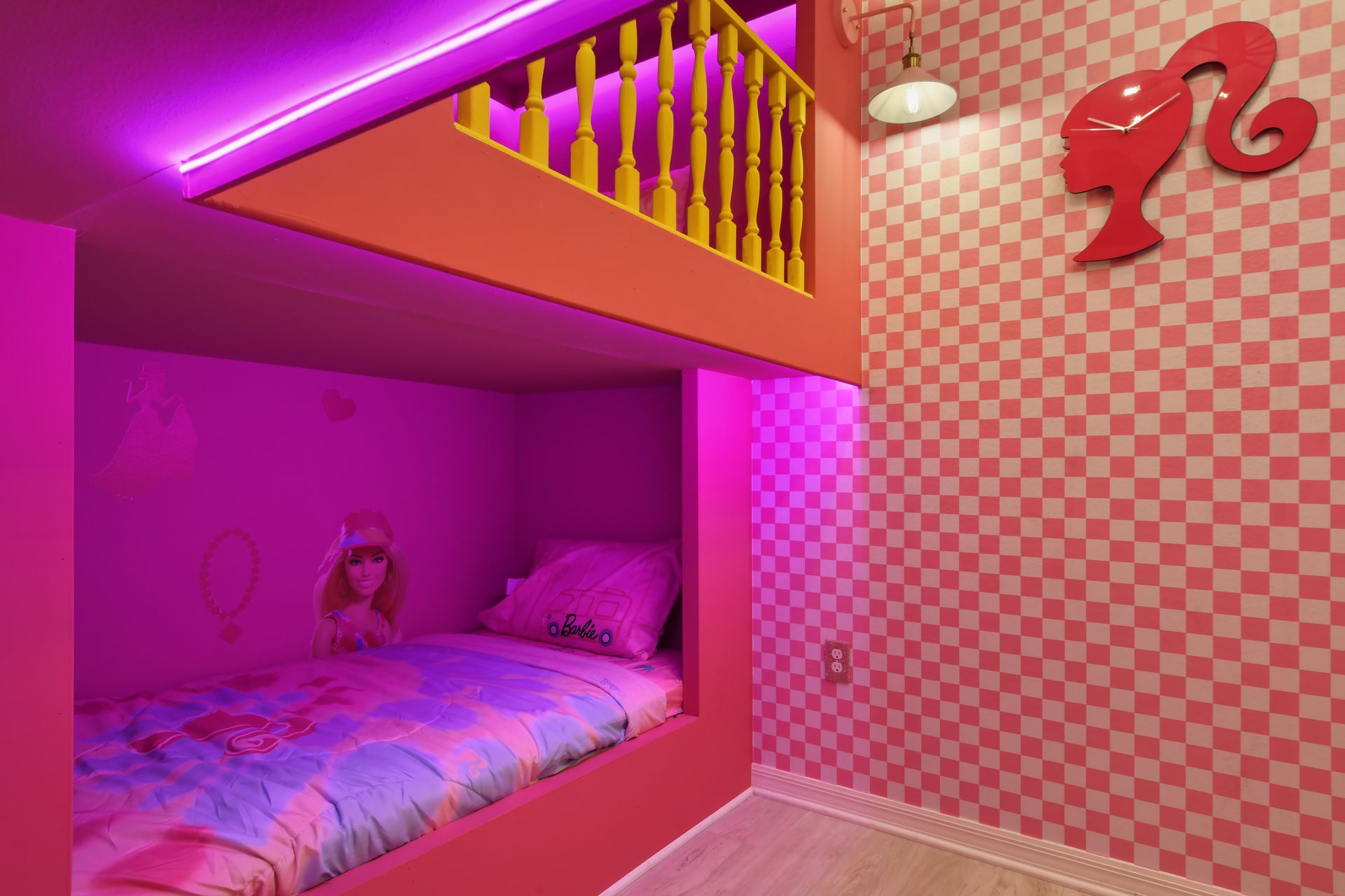 Cozy Barbie-themed bunk bed with vibrant pink decor and fun details!