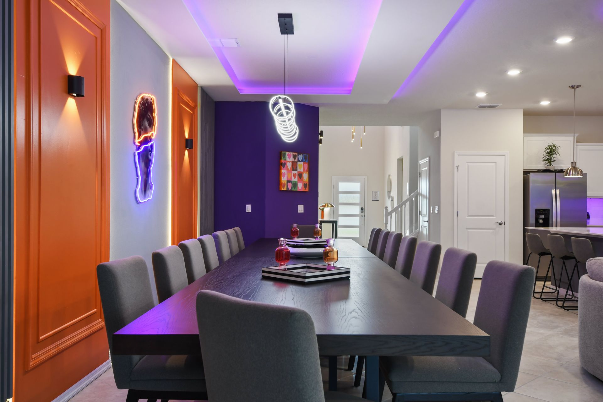 Chic dining area with modern decor, neon accents, and spacious seating.
