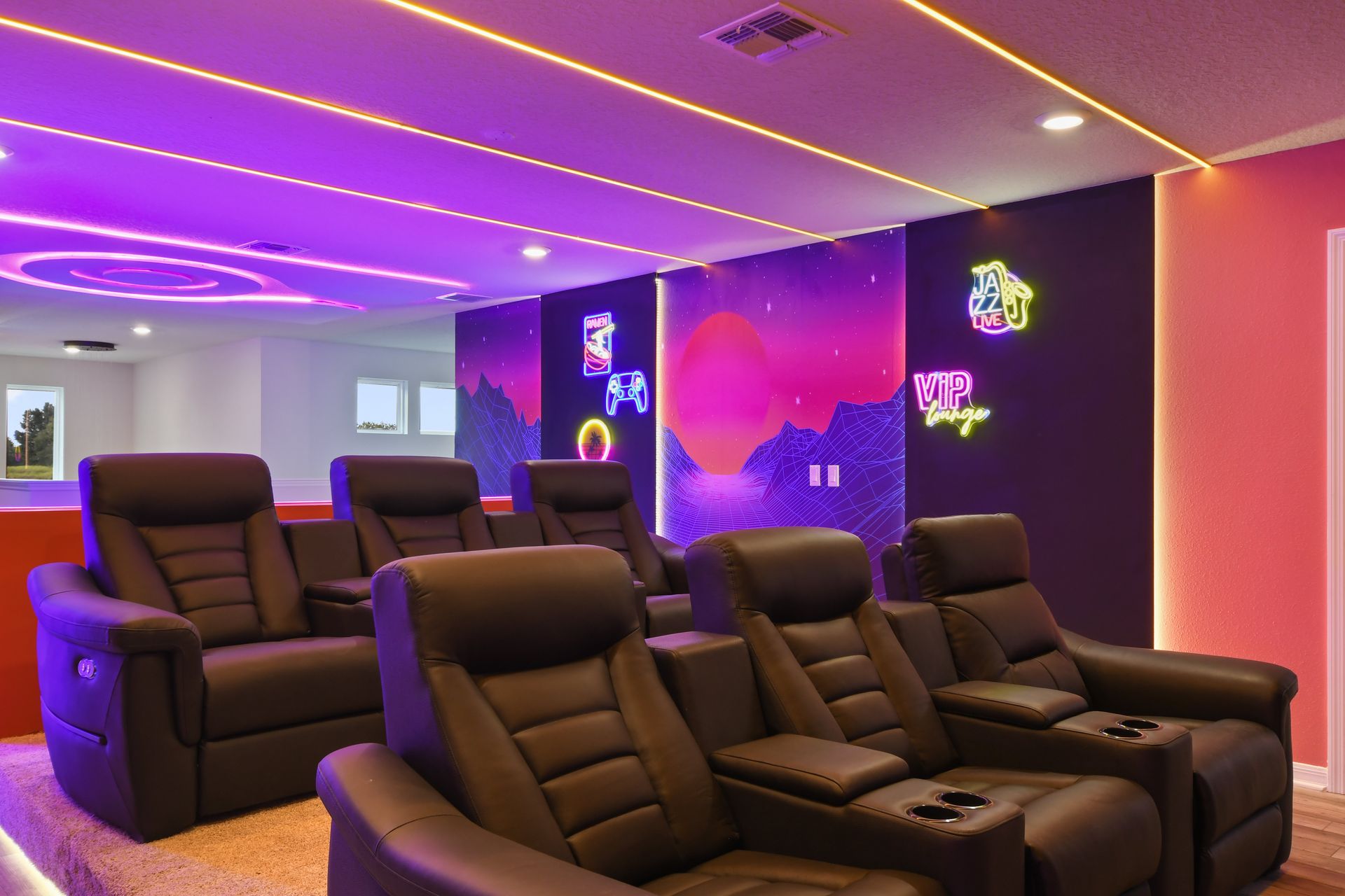 Home theater with plush recliners, neon lights, and retro vibes