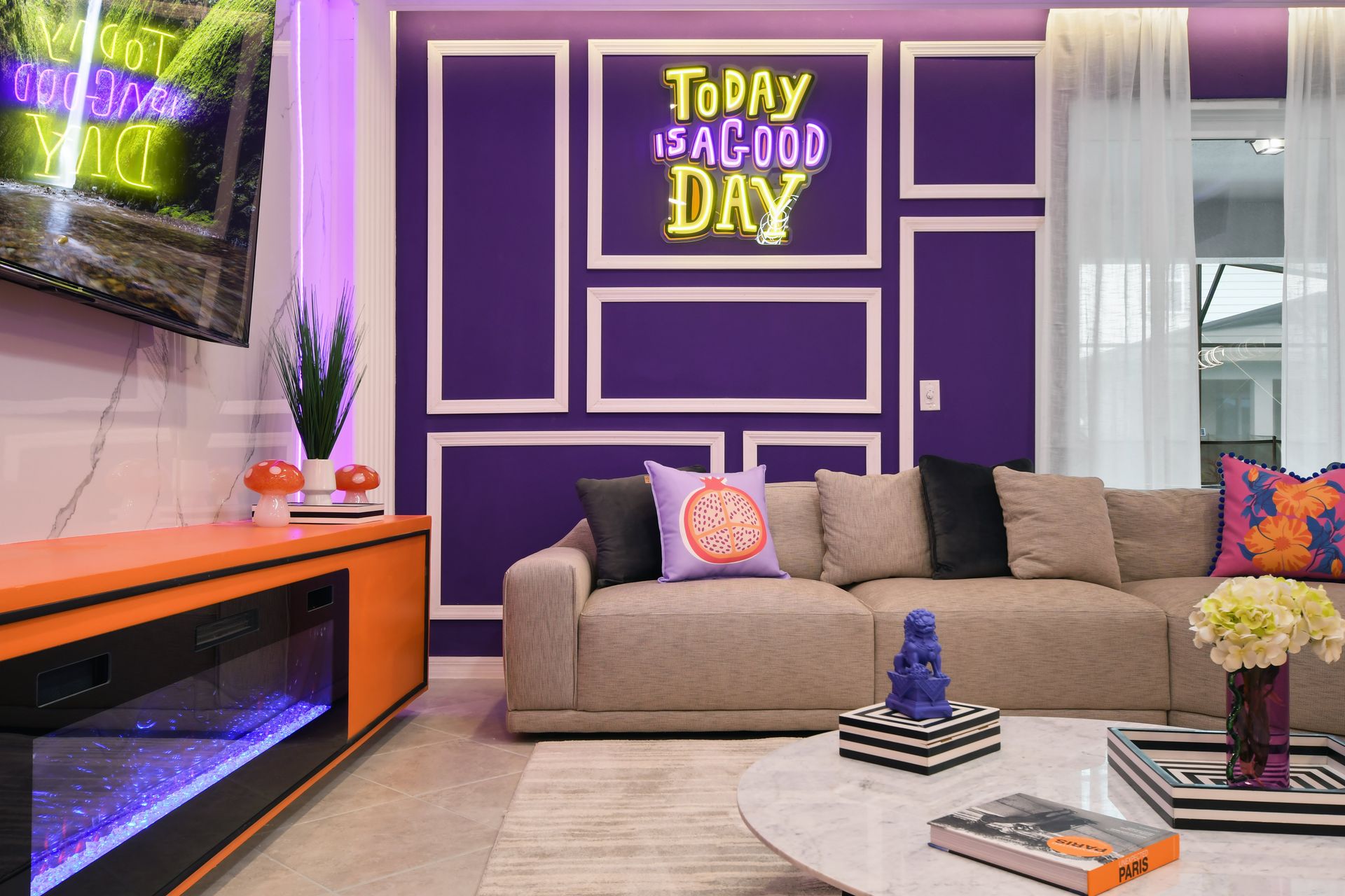 Cozy living room with bold decor, neon accents, and vibrant, modern style.