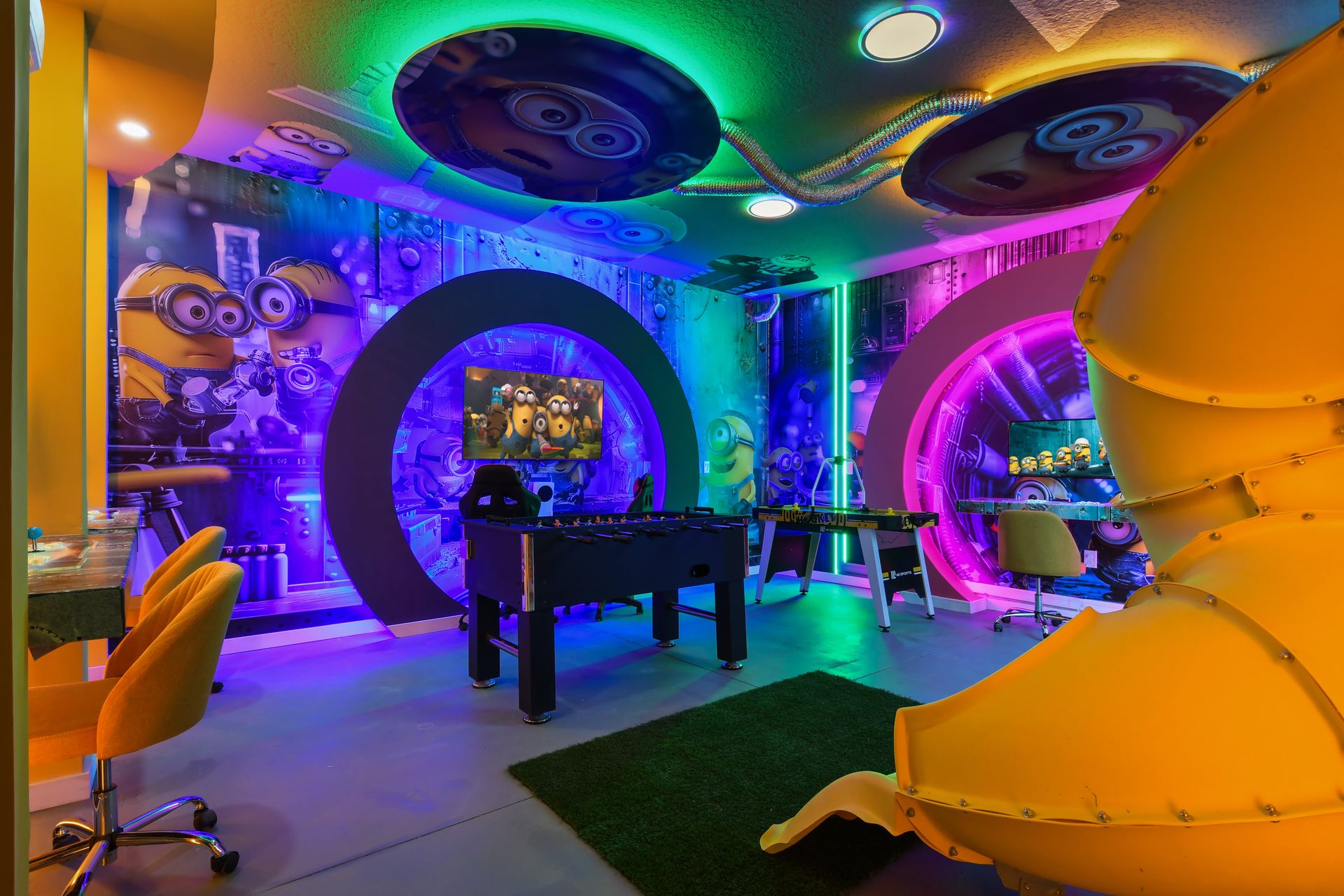 Immersive Minion-themed game room with vibrant lights, slide, and arcade fun.