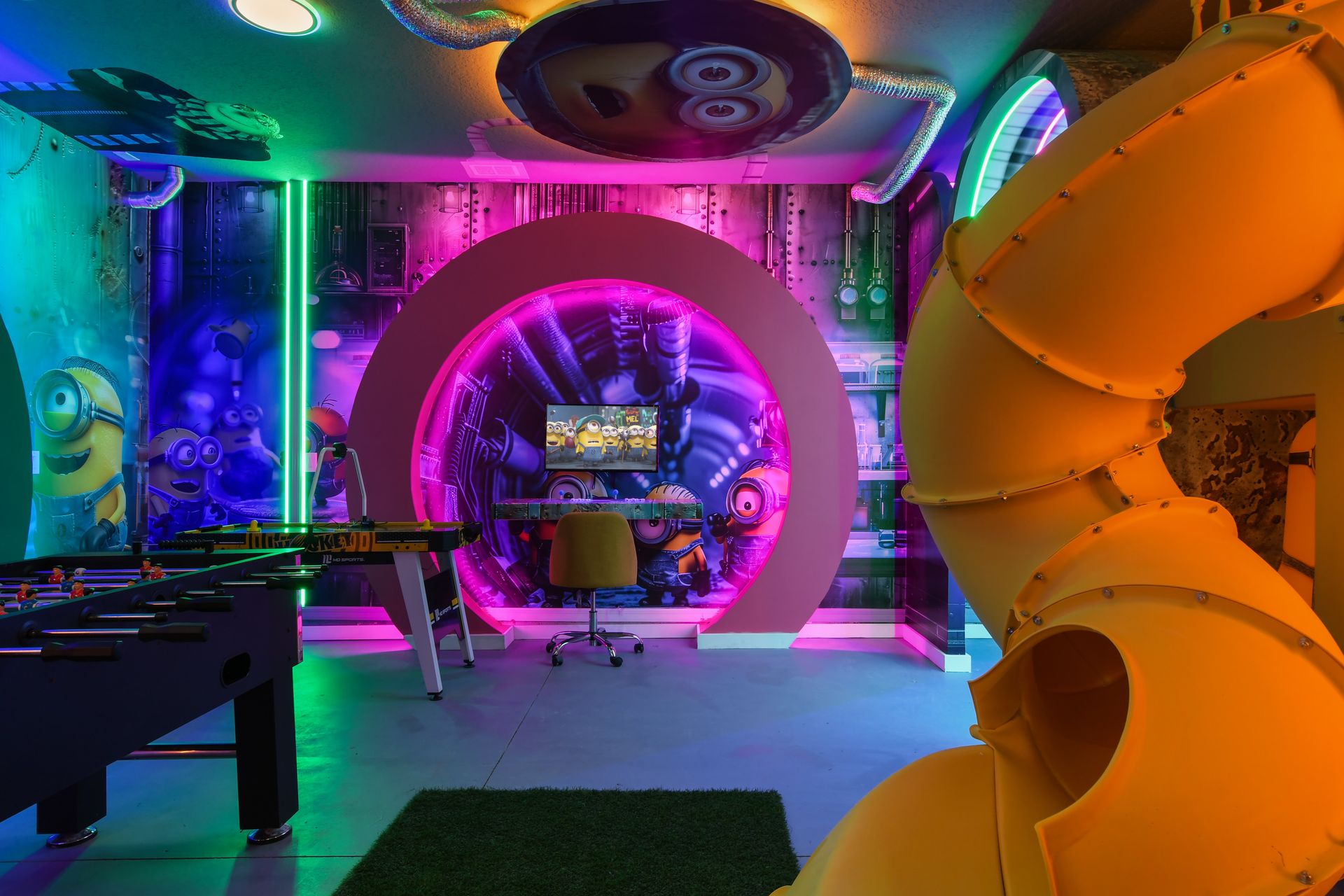 Minion-themed game room with slide, neon lights, and fun-filled arcade games.