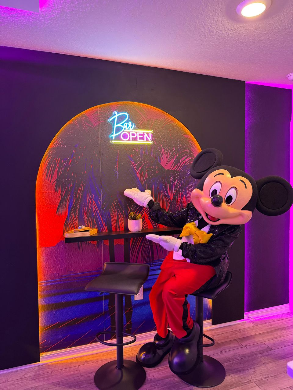 Neon-lit bar lounge with tropical vibes and a touch of magic!