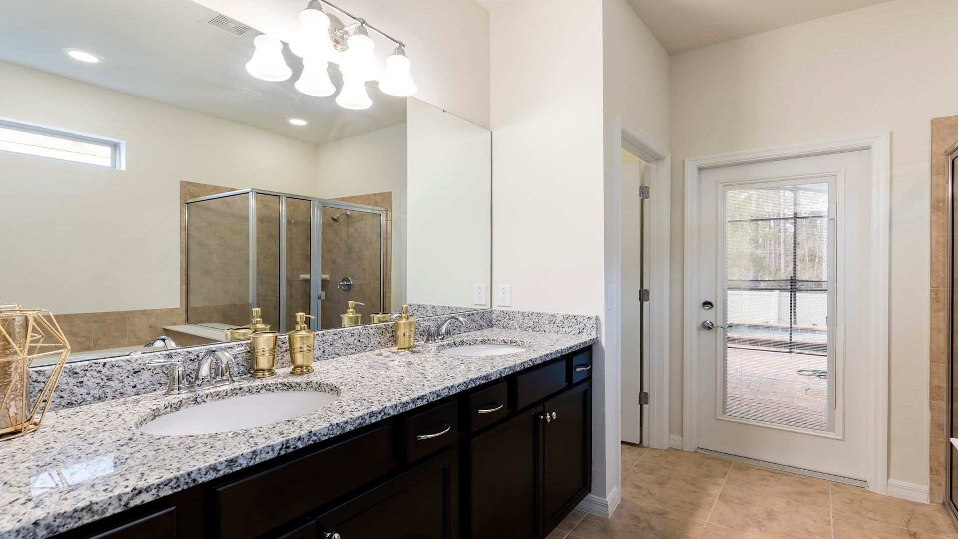 Sleek and modern bathroom with granite countertops and a spacious glass-enclosed shower!