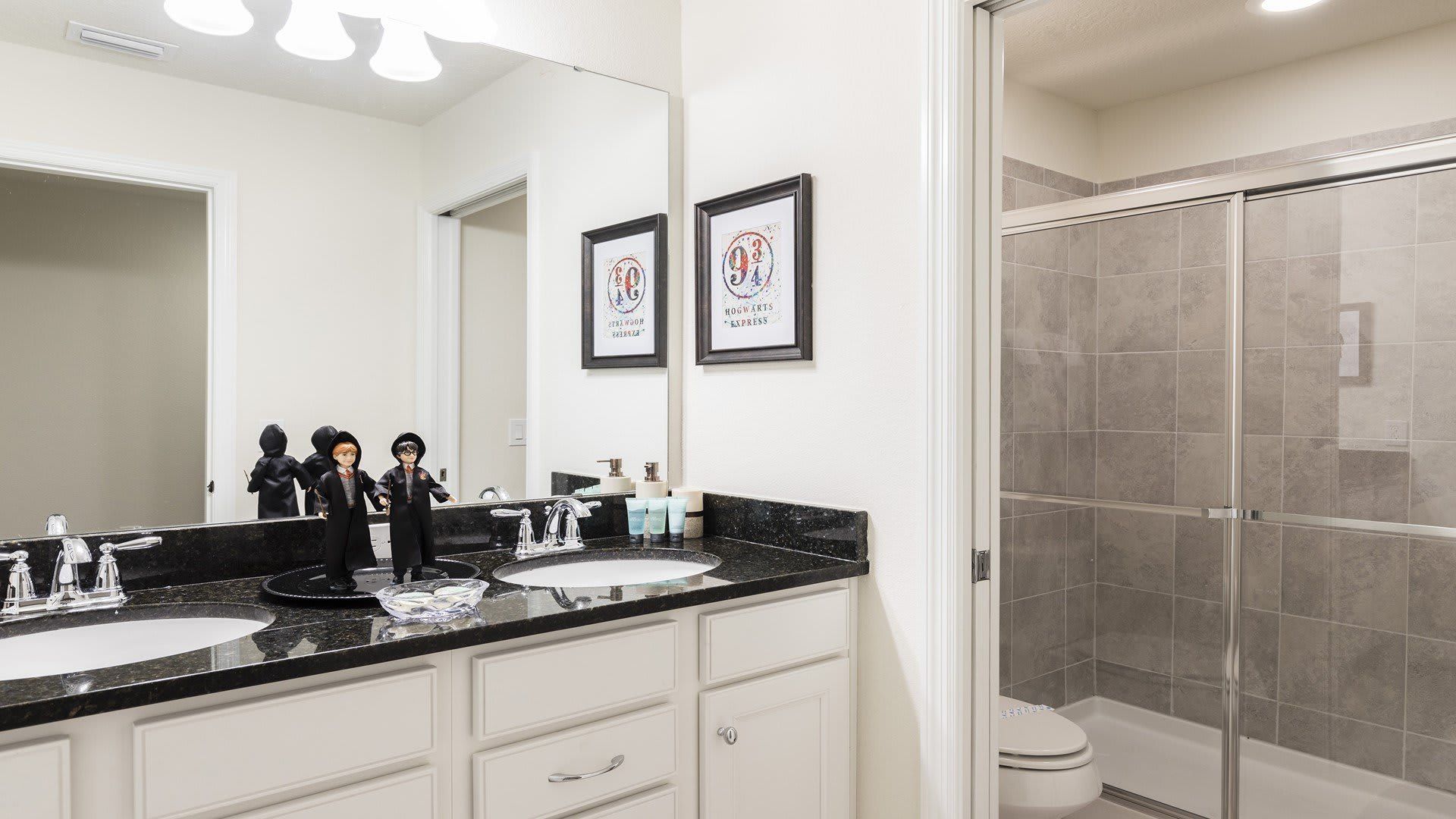 Sleek and modern bathroom with granite countertops and a spacious glass-enclosed shower!