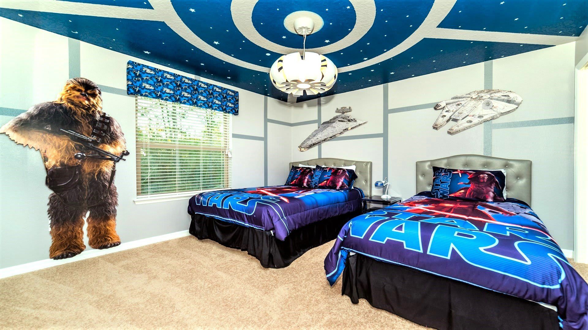 Star Wars-themed bedroom with spaceship ceiling, character cutouts, and twin beds for a fun adventure.