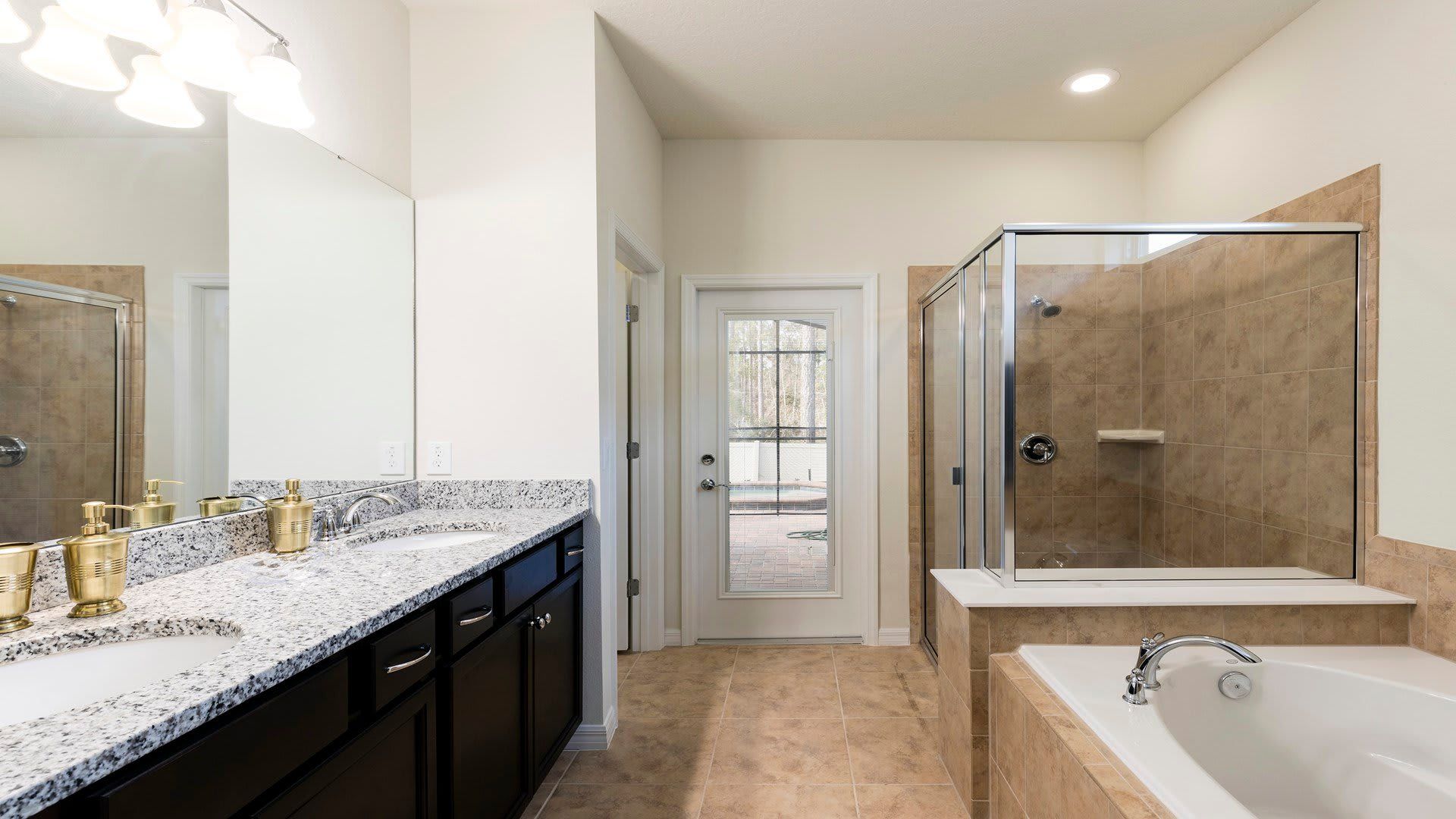 Modern bathroom with dual granite sinks, vibrant decor, and a sleek glass-enclosed shower!
