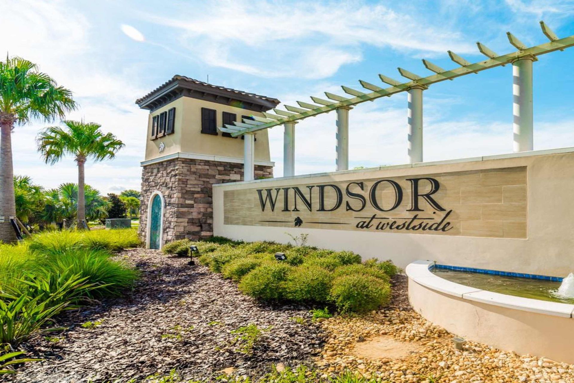 Welcome to Windsor at Westside! Discover luxurious living surrounded by lush landscapes and palm trees.