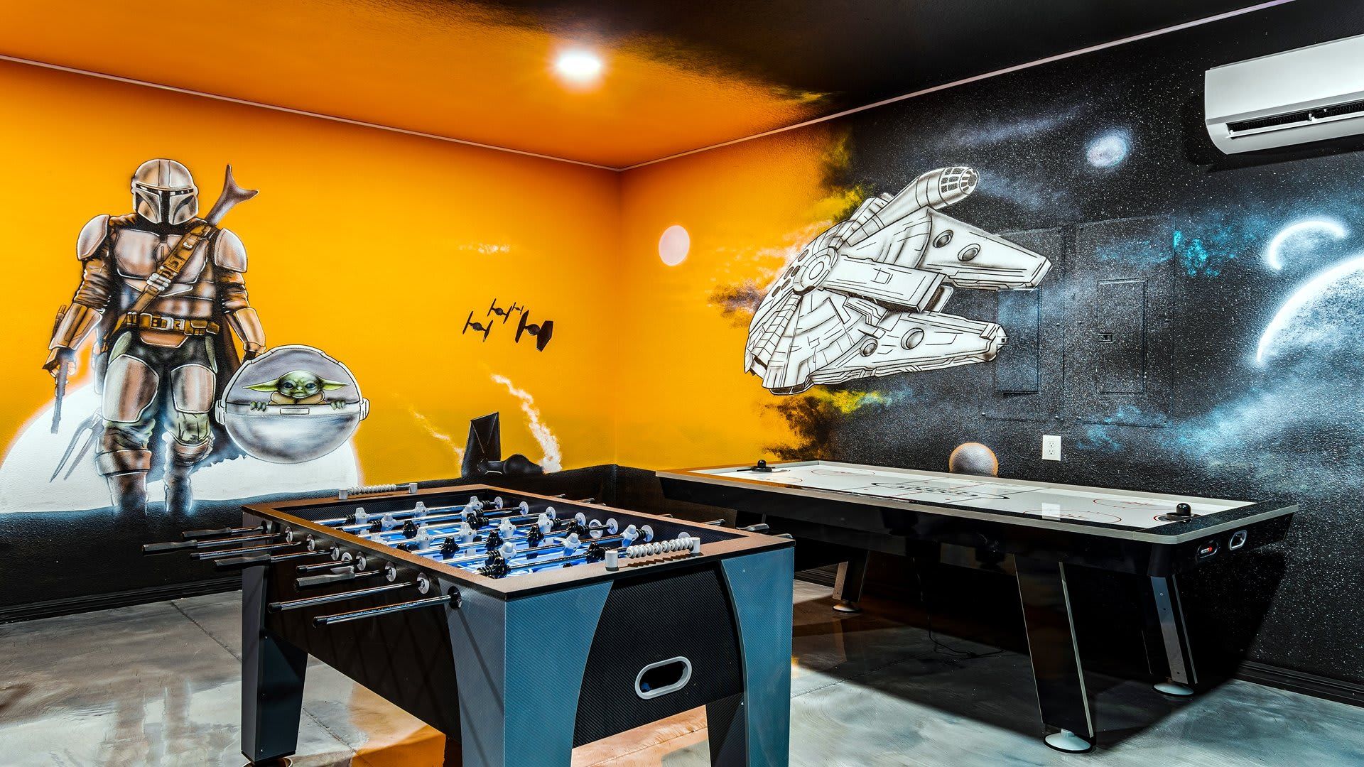 Embark on a galactic adventure in this Star Wars-themed game room with foosball and air hockey!