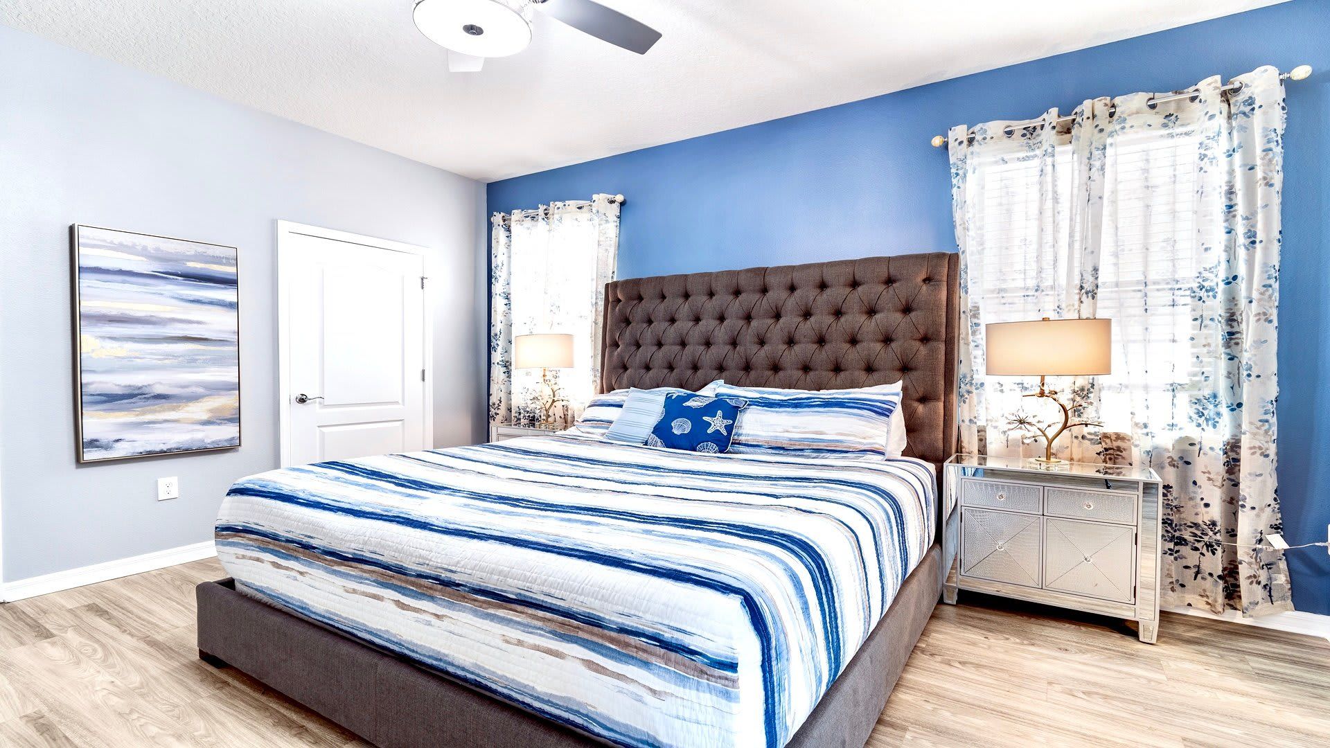 Relax in this chic bedroom with ocean-inspired decor and a plush king-size bed. Coastal comfort awaits!