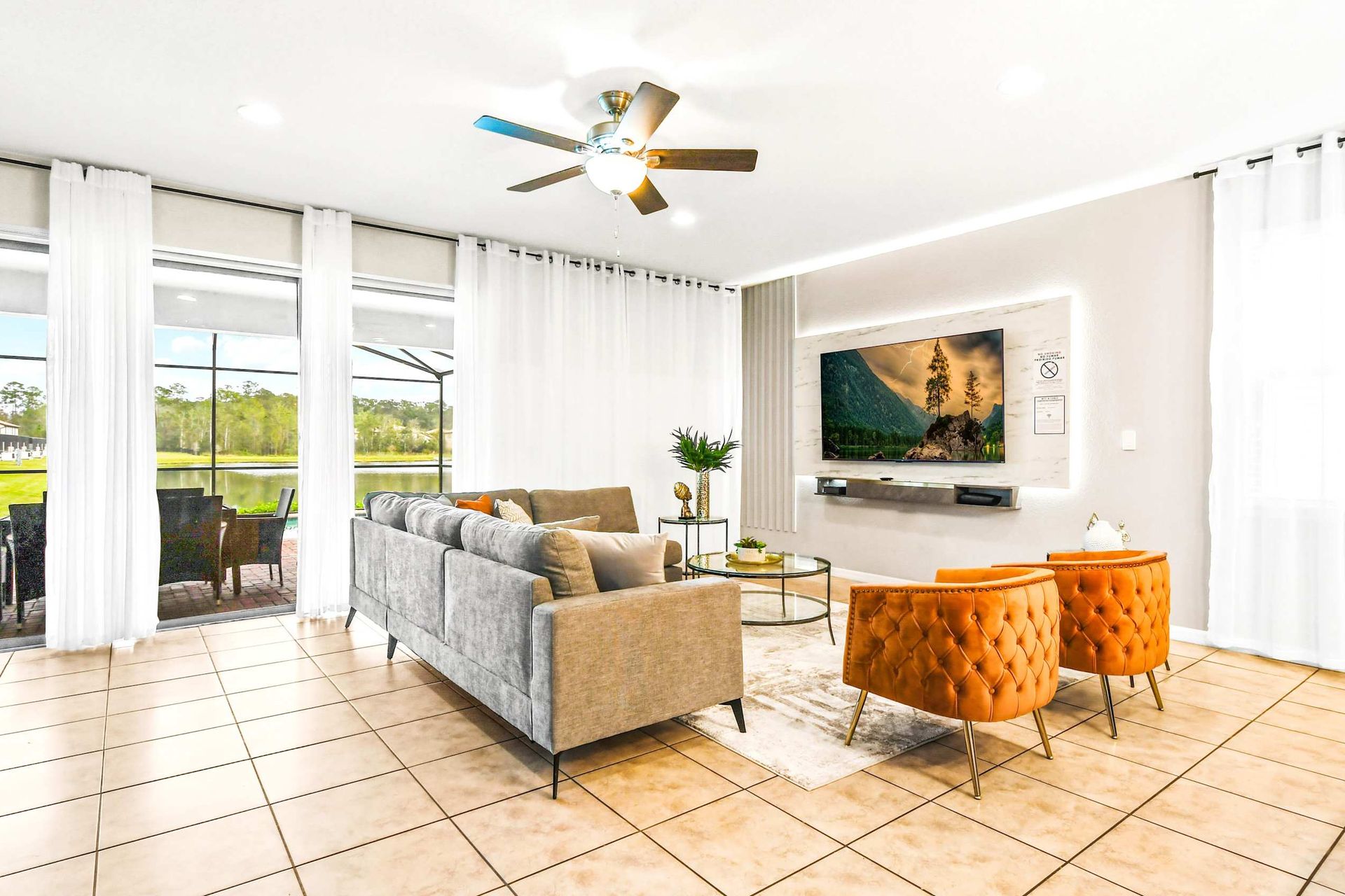 Bright and stylish living space with lake views, modern decor, and cozy seating!