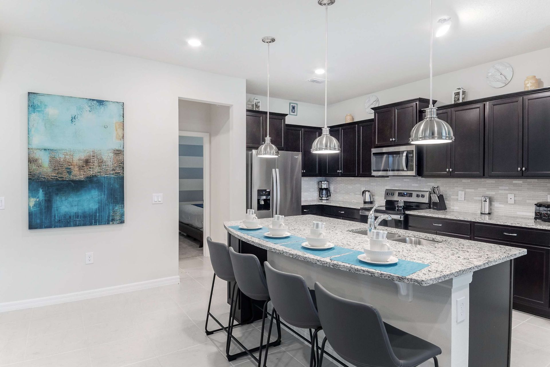 Kitchen: Compact and stylish with a mini breakfast bar, offering a cozy space for quick and casual dining