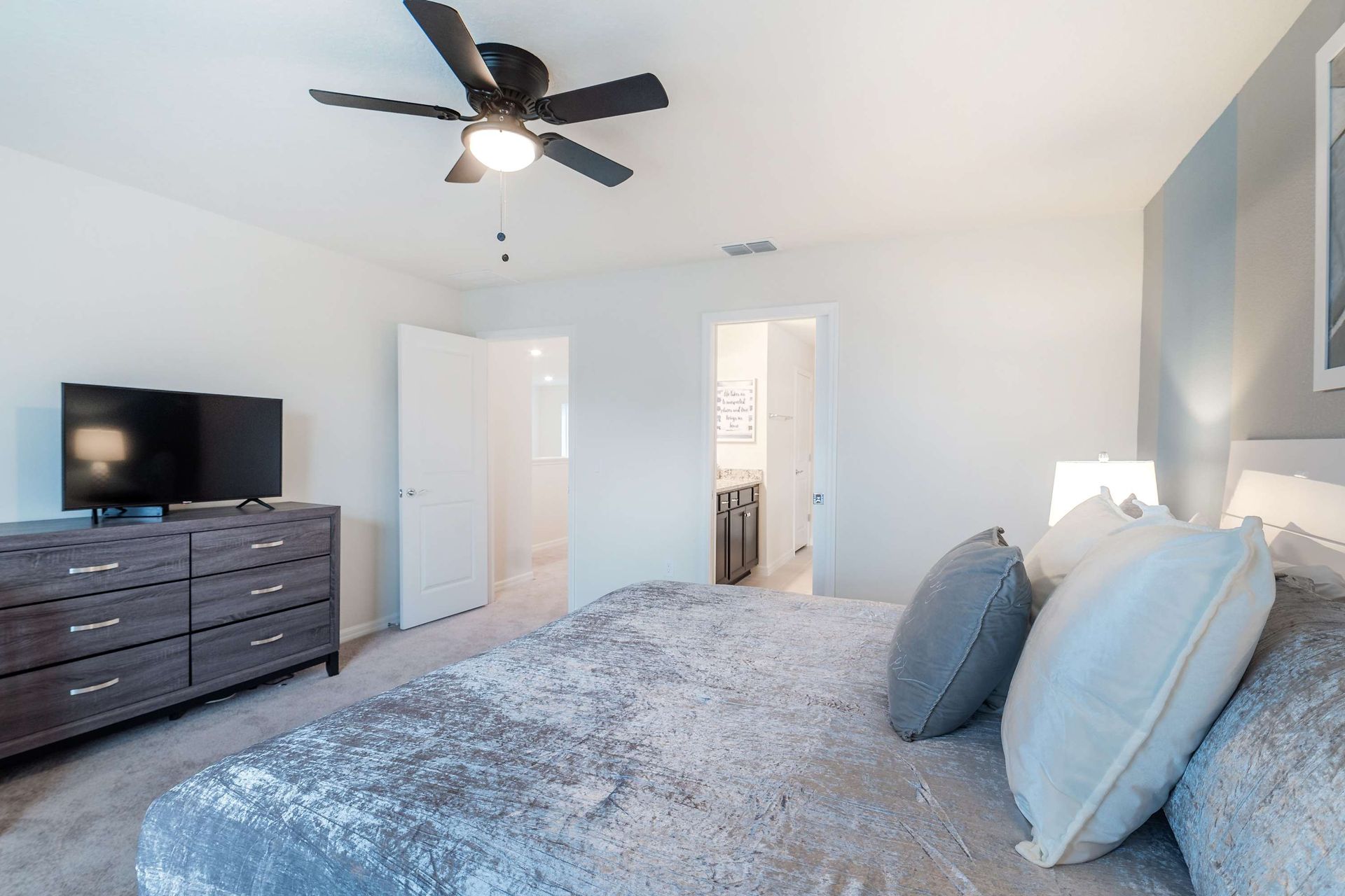 Queen-sized comfort with a TV, offering a cozy and entertainment-ready haven.