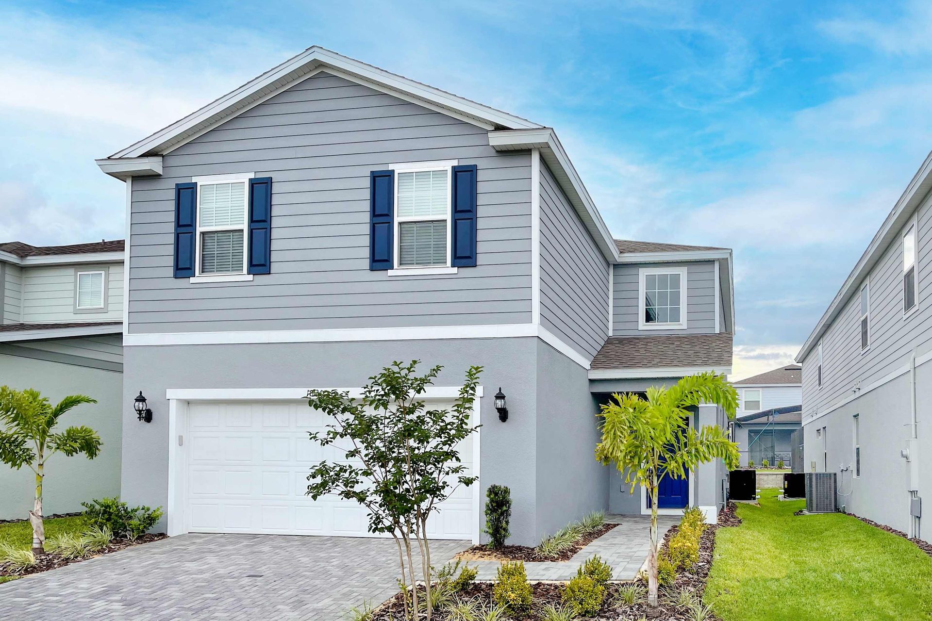 Home Exterior: Modern elegance meets lush greenery, creating a harmonious and inviting outdoor space