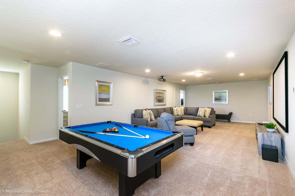 Spacious game & movie room with pool table, projector & cozy seating—fun for all!