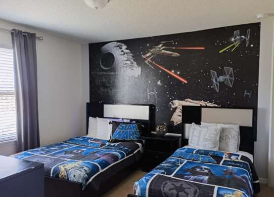 Epic Star Wars-themed bedroom with twin beds—perfect for young Jedi & space adventurers!