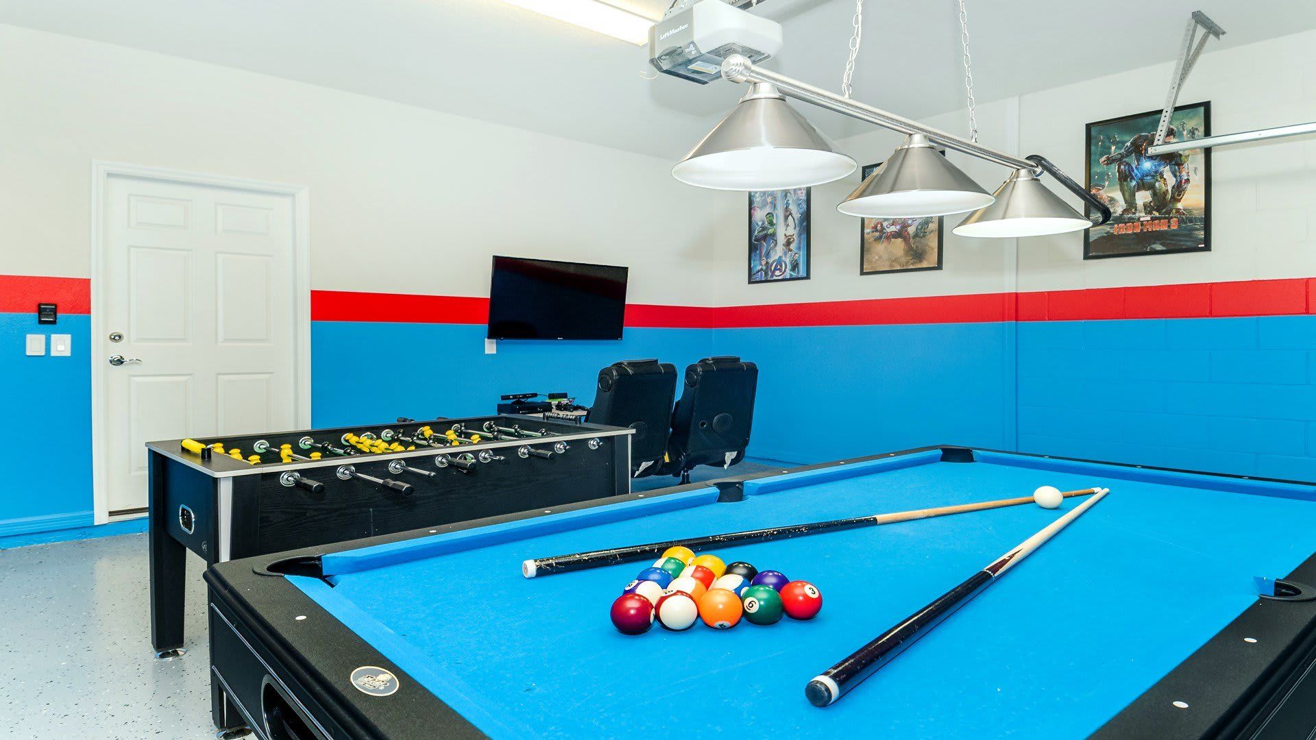 The game room is stylishly furnished with pool table and foosball table