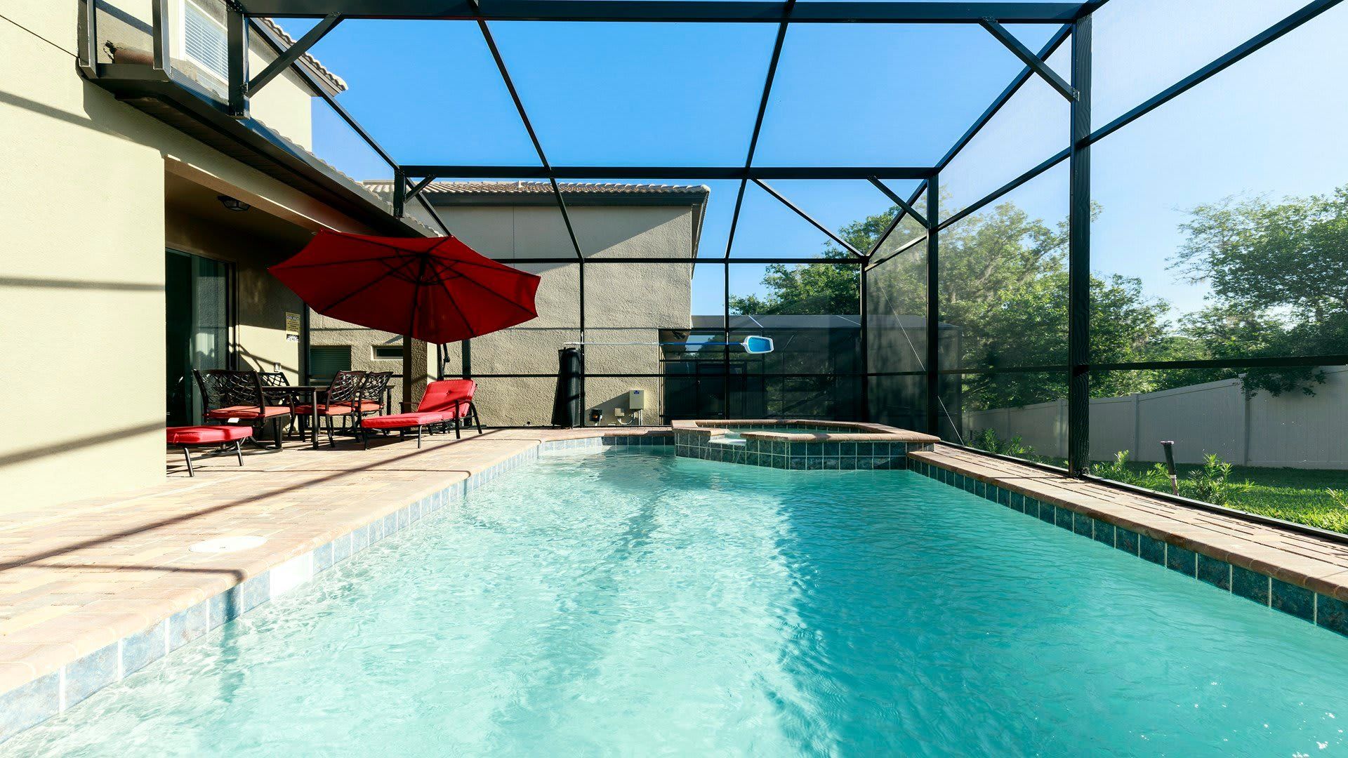 Private Retreat: Exclusive access to a screened-in spa and pool, providing a secluded and relaxing escape for ultimate enjoyment