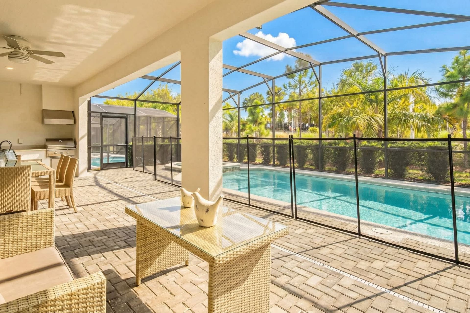 Relaxing screened-in patio with a private pool, outdoor dining, and a built-in grill!