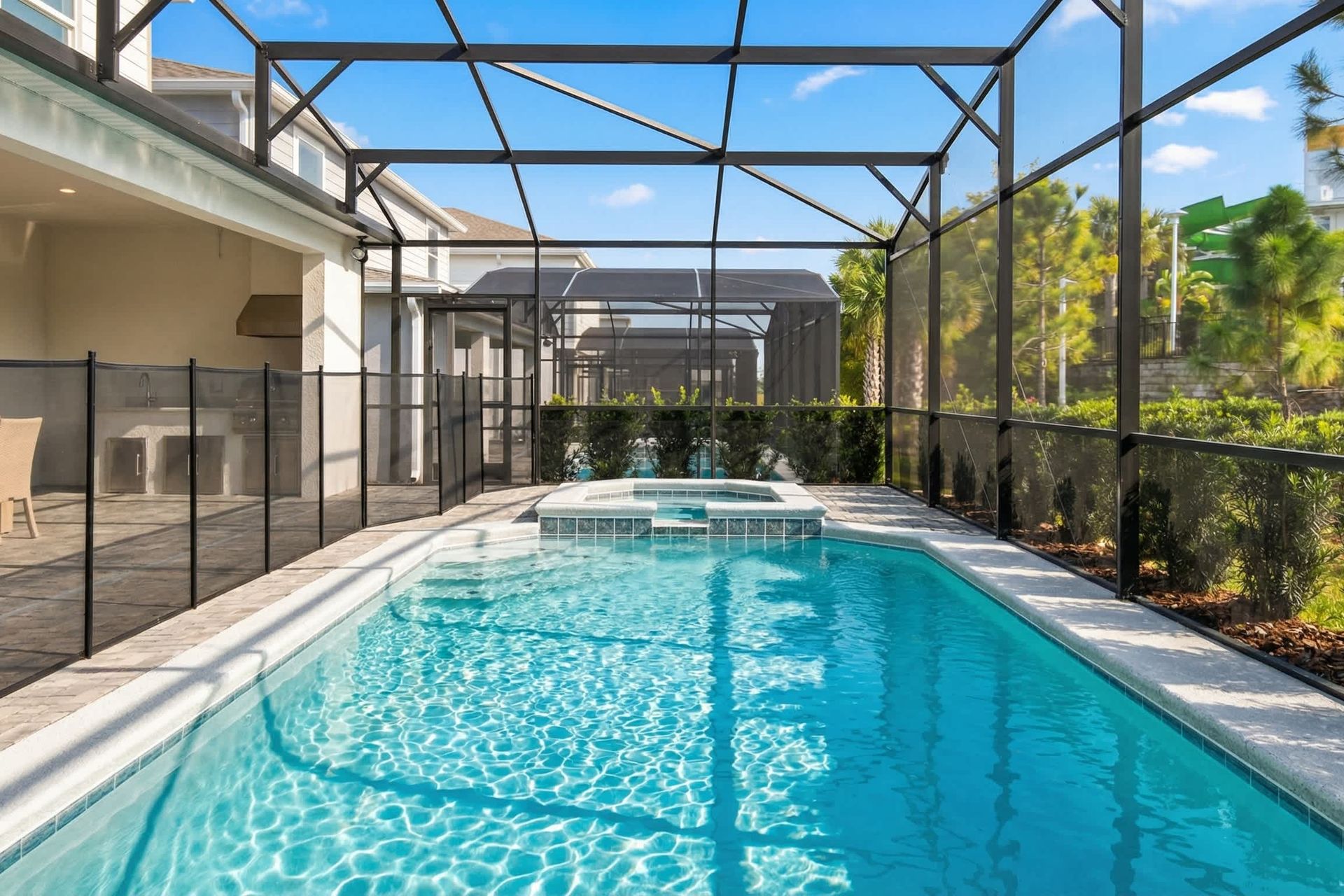 Private screened-in pool and spa with outdoor dining, lounge space, and lush views!