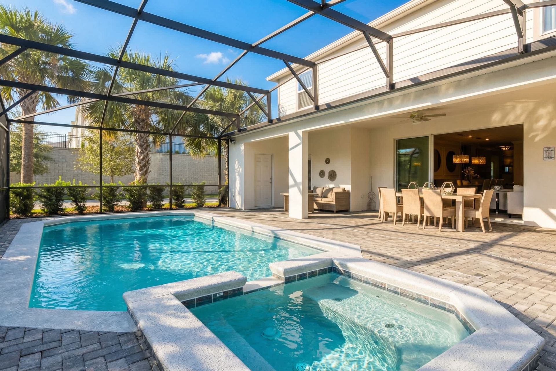 Private screened-in pool and spa with outdoor dining, lounge space, and lush views!