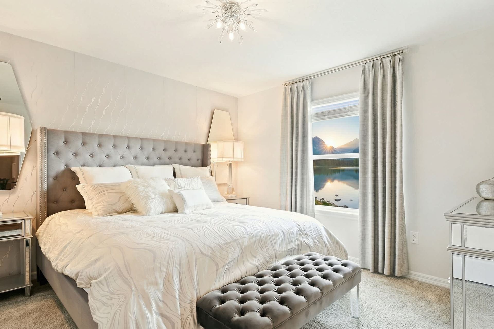 Luxurious bedroom with elegant decor, plush bedding, and a stunning chandelier!