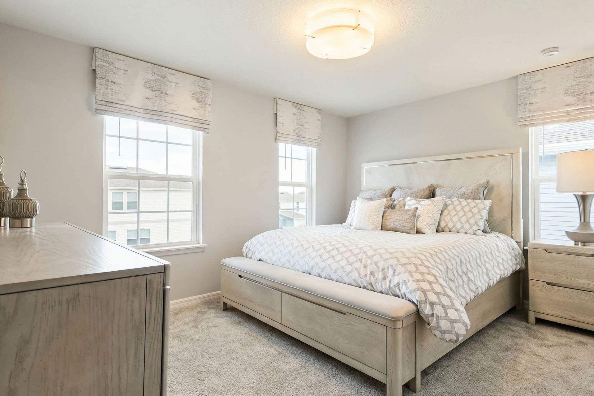 Elegant bedroom with soft neutrals, plush bedding, and abundant natural light!
