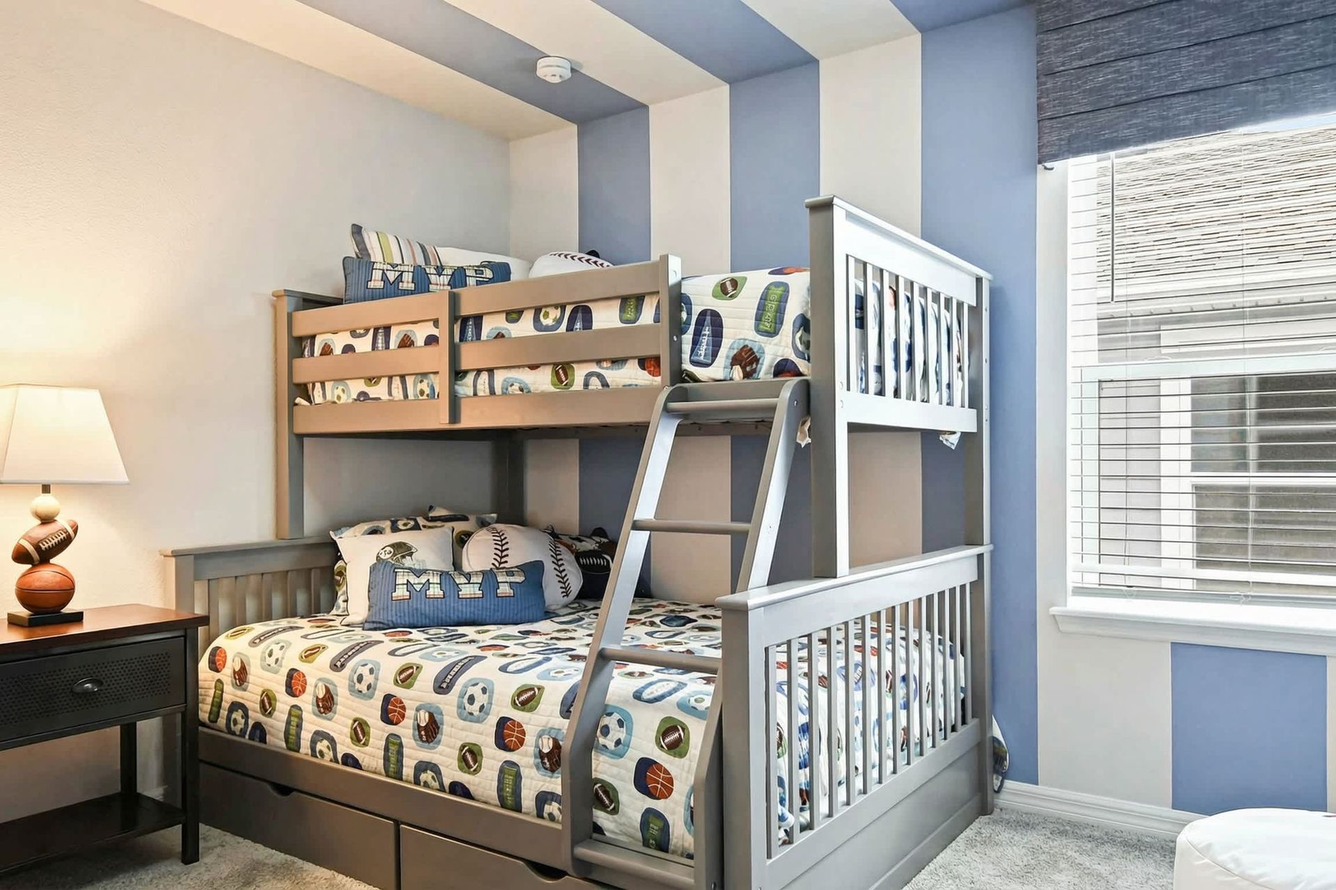 Fun sports-themed bunk room with cozy bedding, bold stripes, and playful decor!