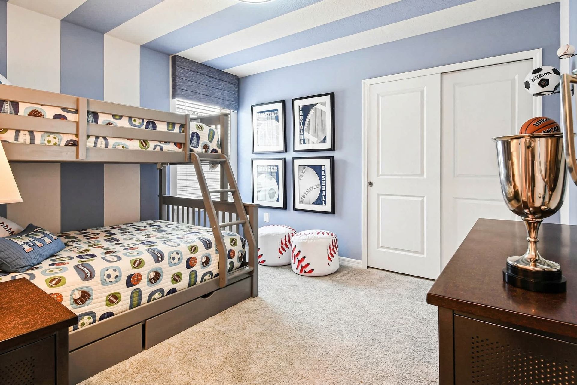 Fun sports-themed bunk room with cozy bedding, bold stripes, and playful decor!