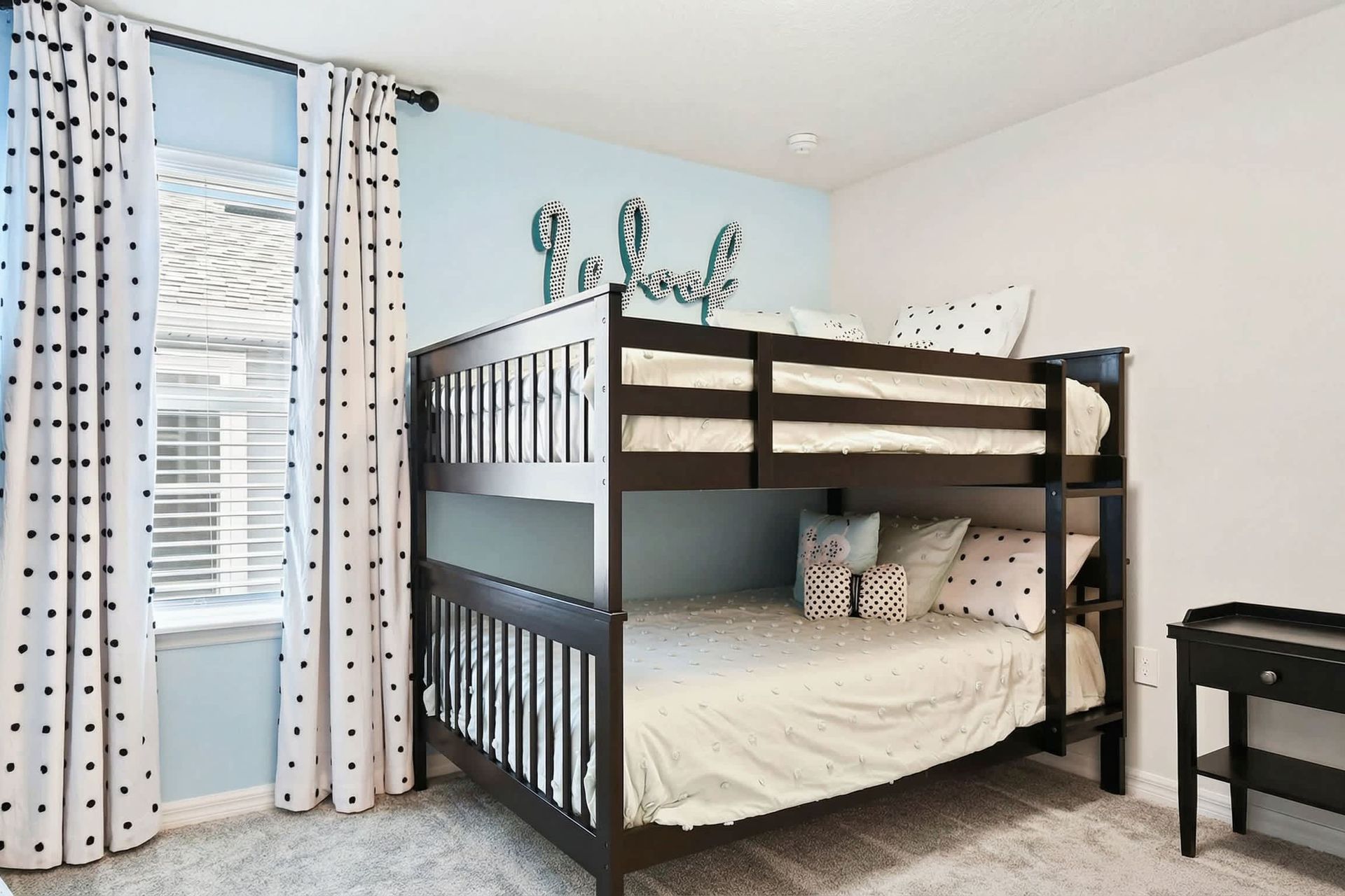 Charming bunk room with playful polka dots, cozy bedding, and a stylish touch!