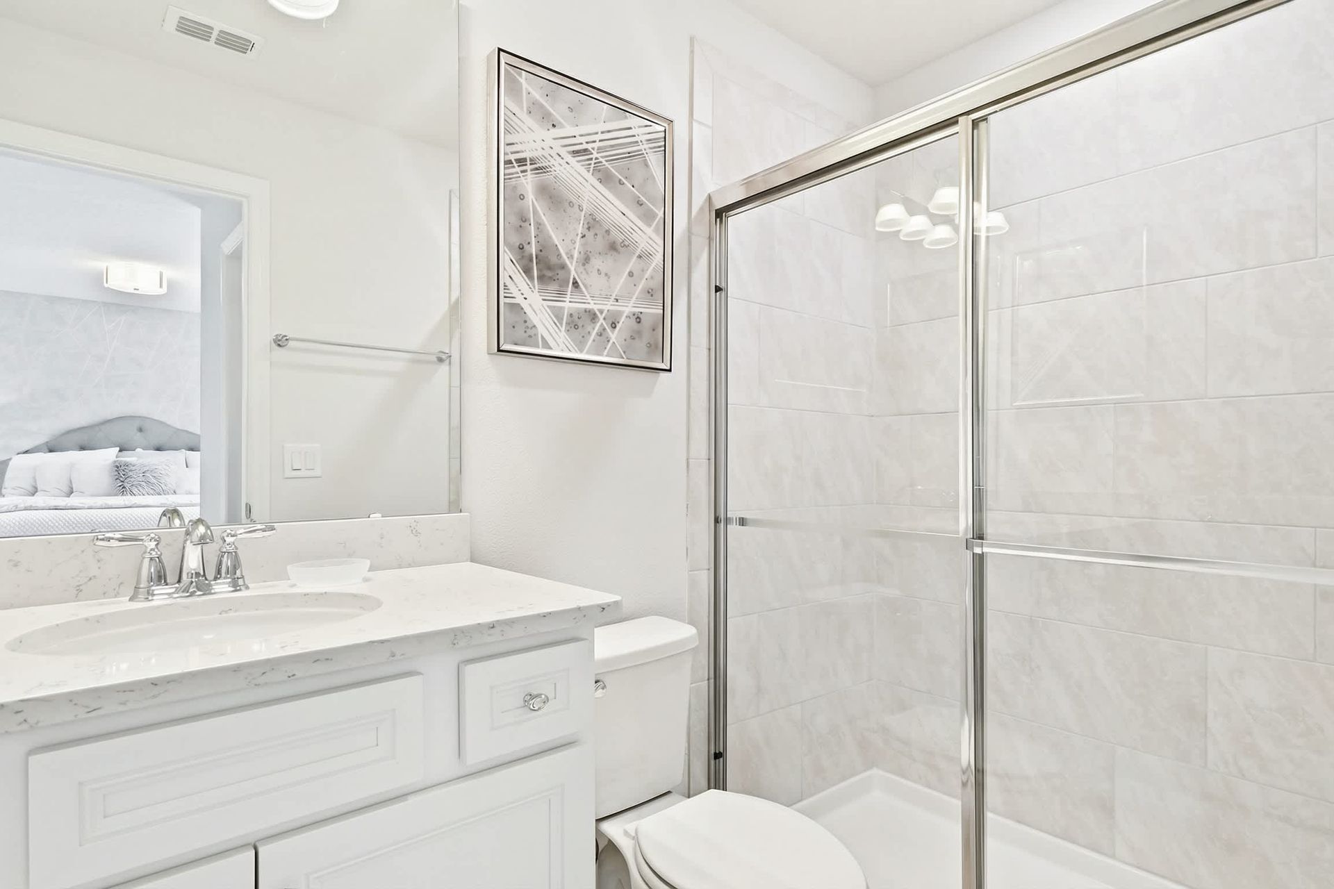 Elegant bathroom with a sleek vanity, glass shower, and bright, modern decor!