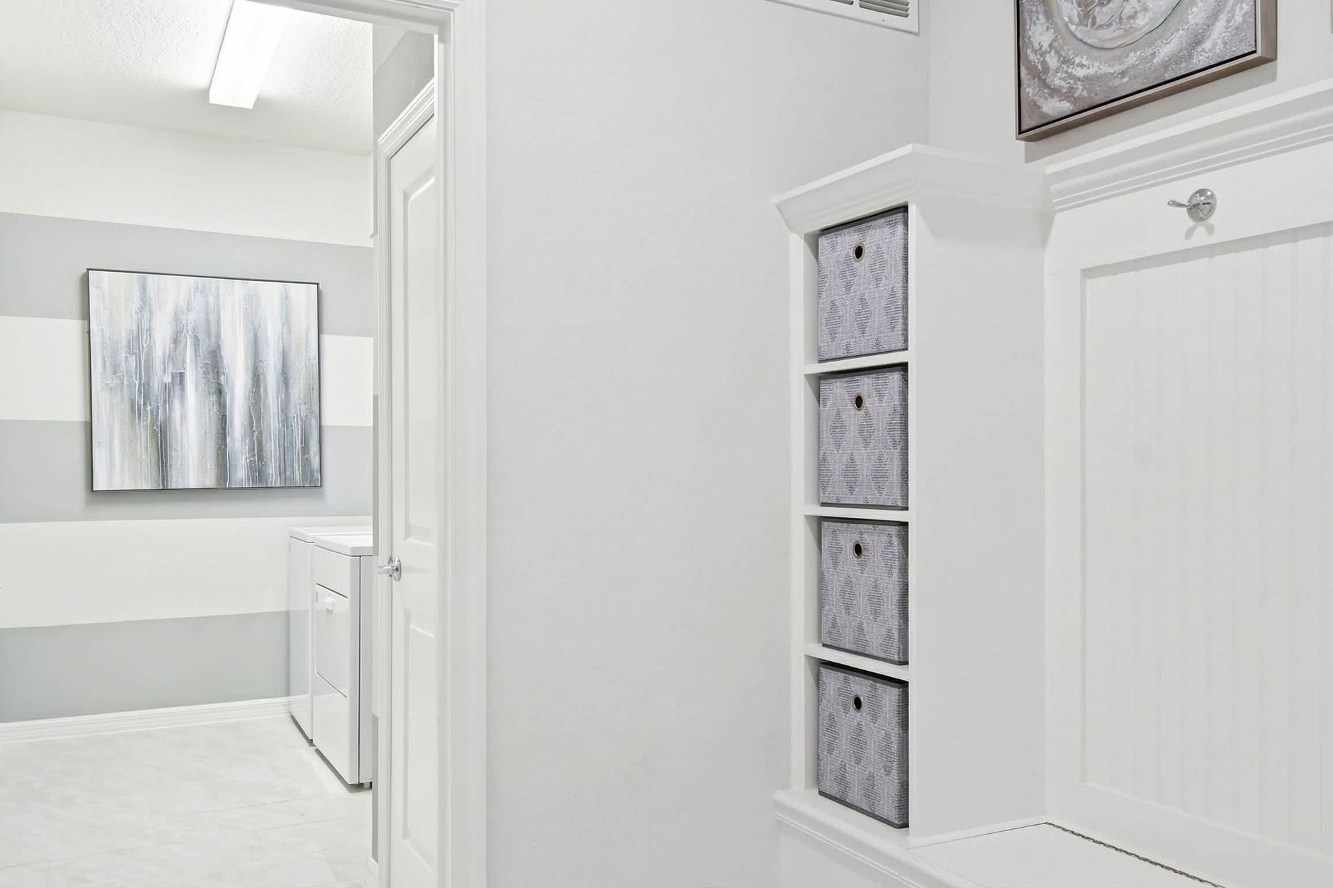 Bright and modern laundry area with built-in storage, stylish decor, and organization!