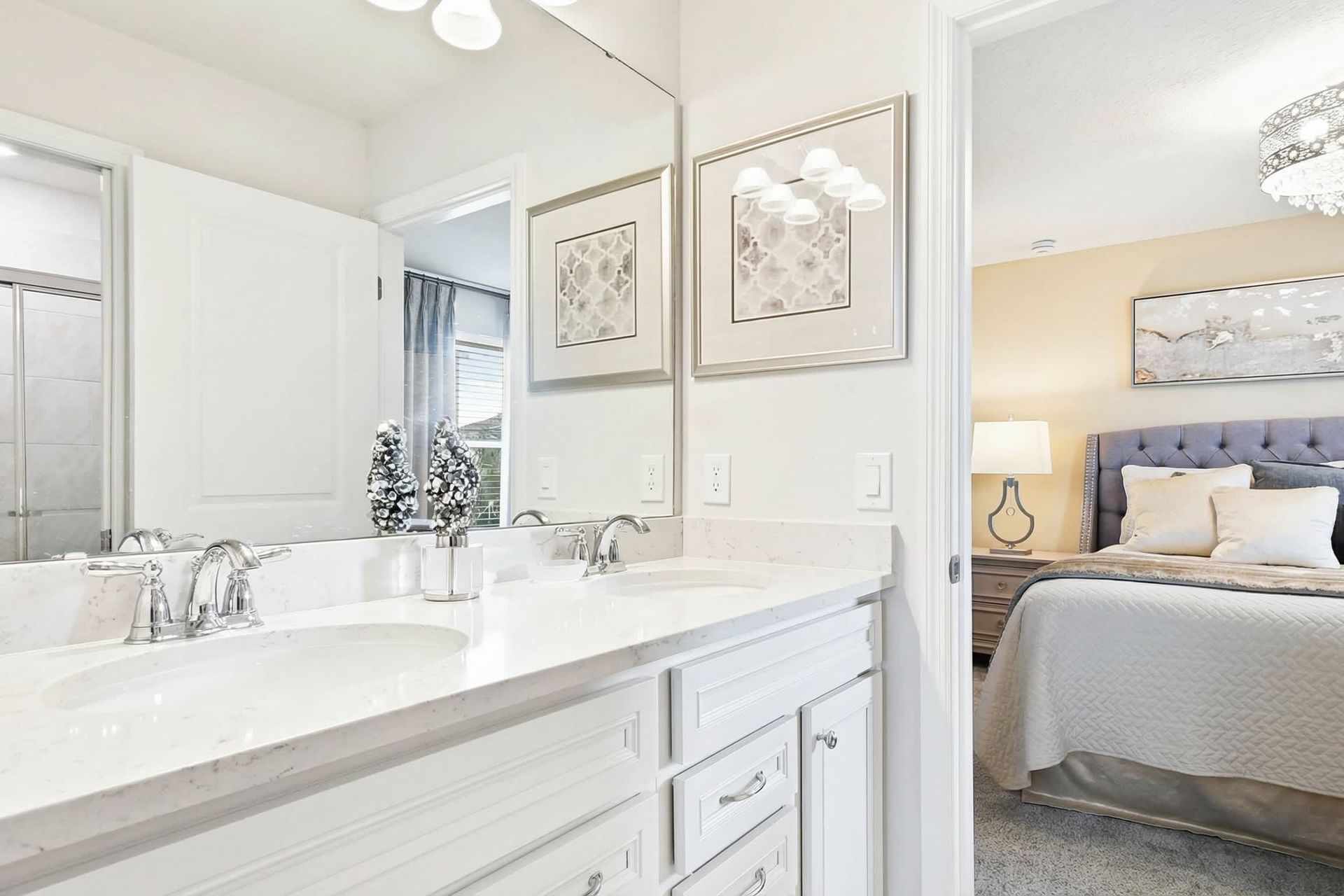 Elegant bathroom with a sleek vanity, glass shower, and bright, modern decor!