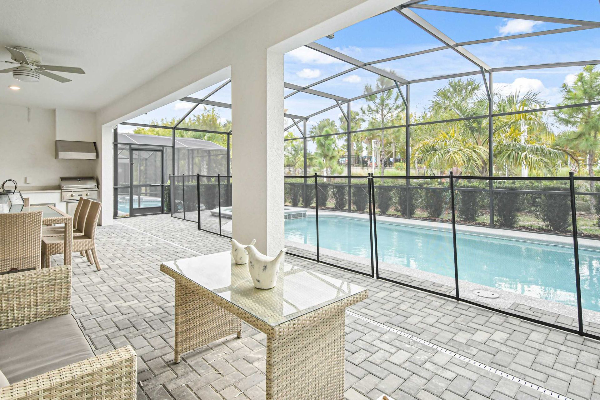Relaxing screened-in patio with a private pool, outdoor dining, and a built-in grill!