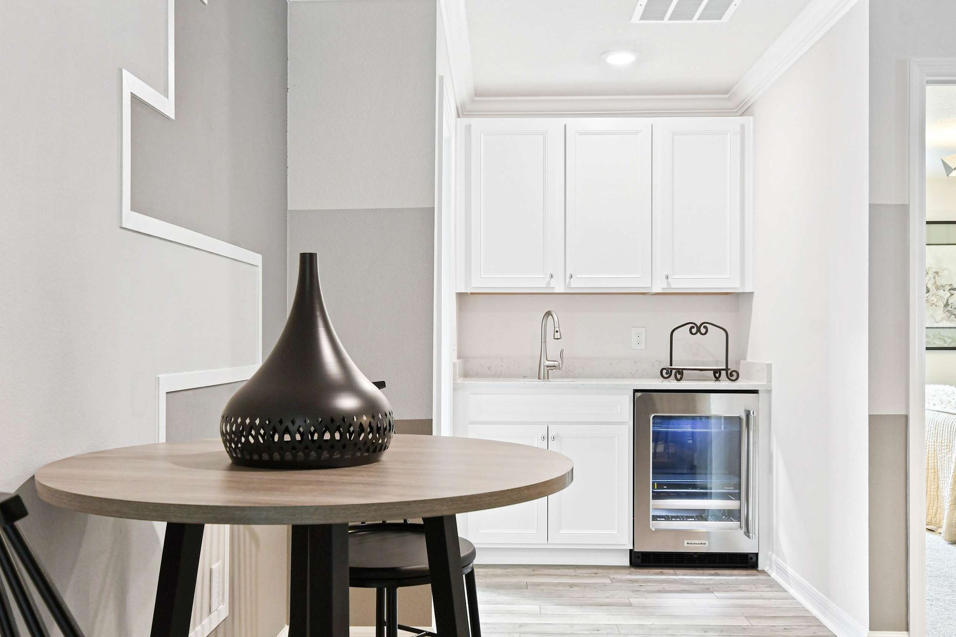 Stylish kitchenette with sleek decor, a mini fridge, and a cozy dining nook!