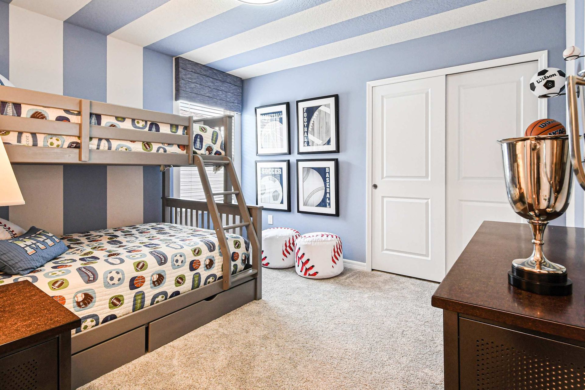 Fun sports-themed bunk room with cozy bedding, bold stripes, and playful decor!