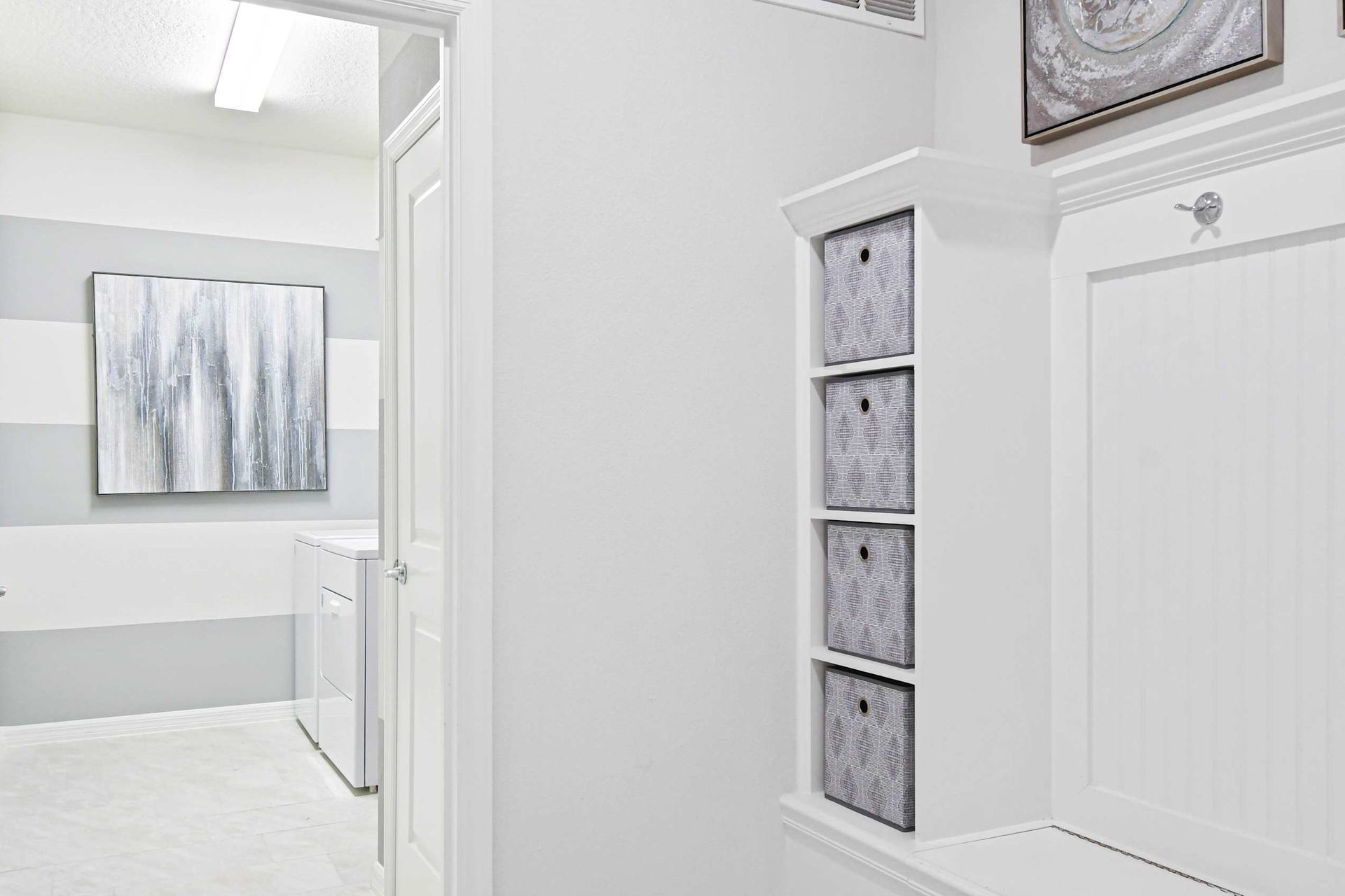 Bright and modern laundry area with built-in storage, stylish decor, and organization!