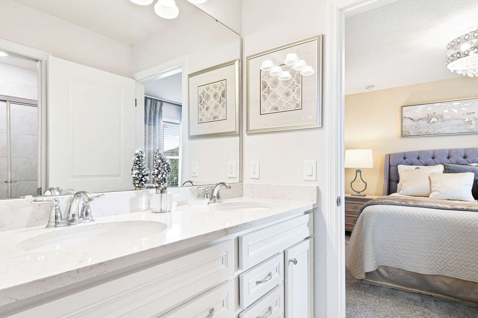 Elegant bathroom with a sleek vanity, glass shower, and bright, modern decor!