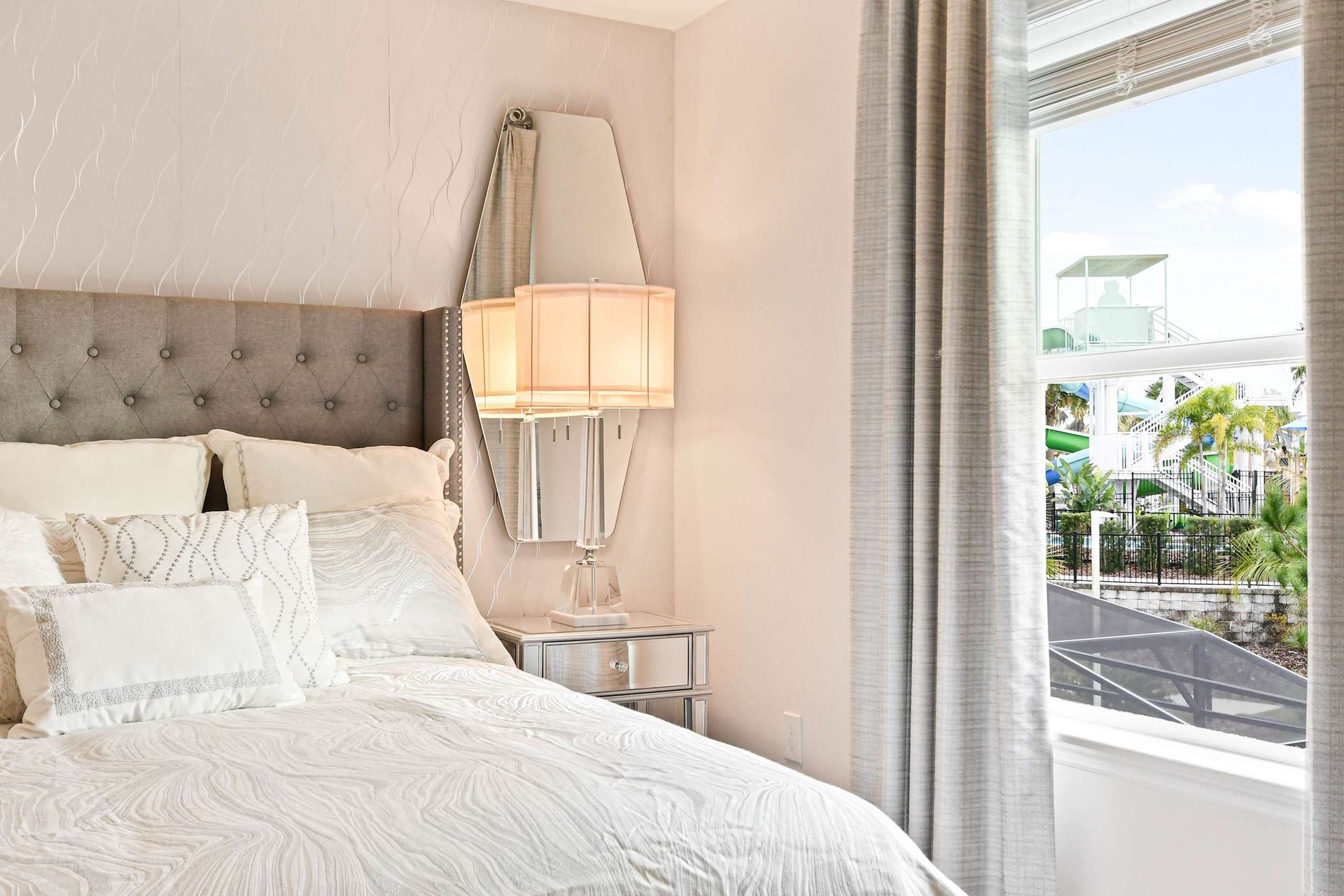 Chic bedroom with plush bedding, elegant decor, and a view of a fun water park!