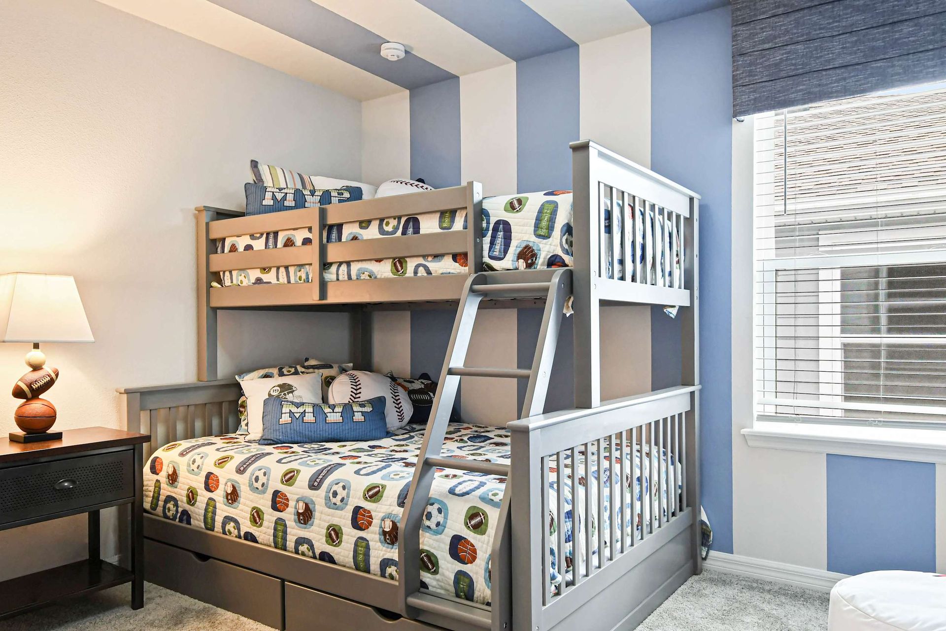 Fun sports-themed bunk room with cozy bedding, bold stripes, and playful decor!