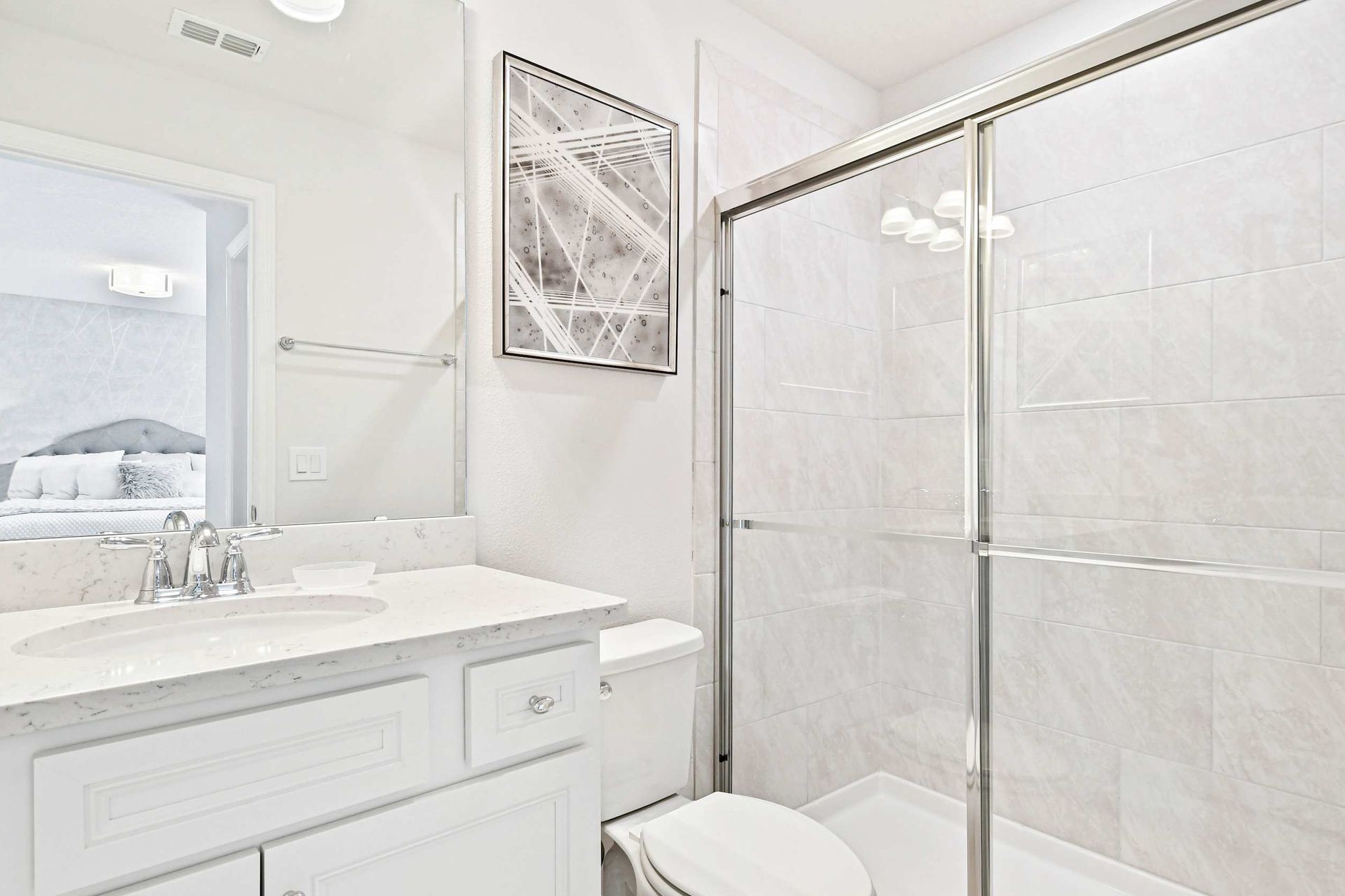 Elegant bathroom with a sleek vanity, glass shower, and bright, modern decor!