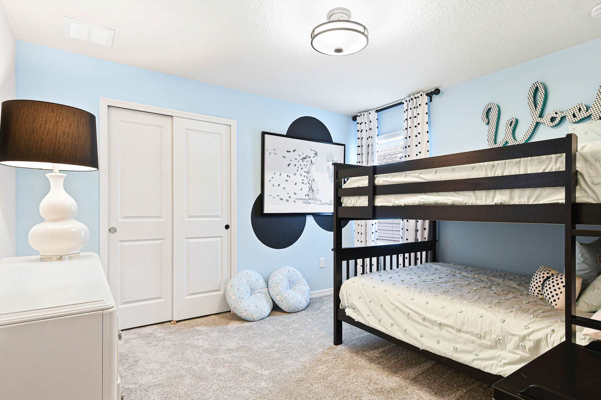 Charming bunk room with playful polka dots, cozy bedding, and a stylish touch!
