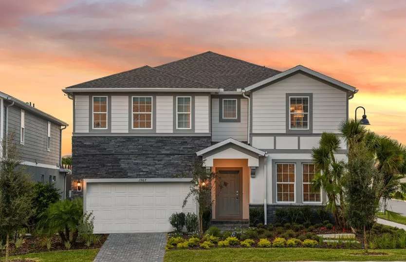 Stunning modern home with elegant design, lush landscaping, and a warm sunset glow!