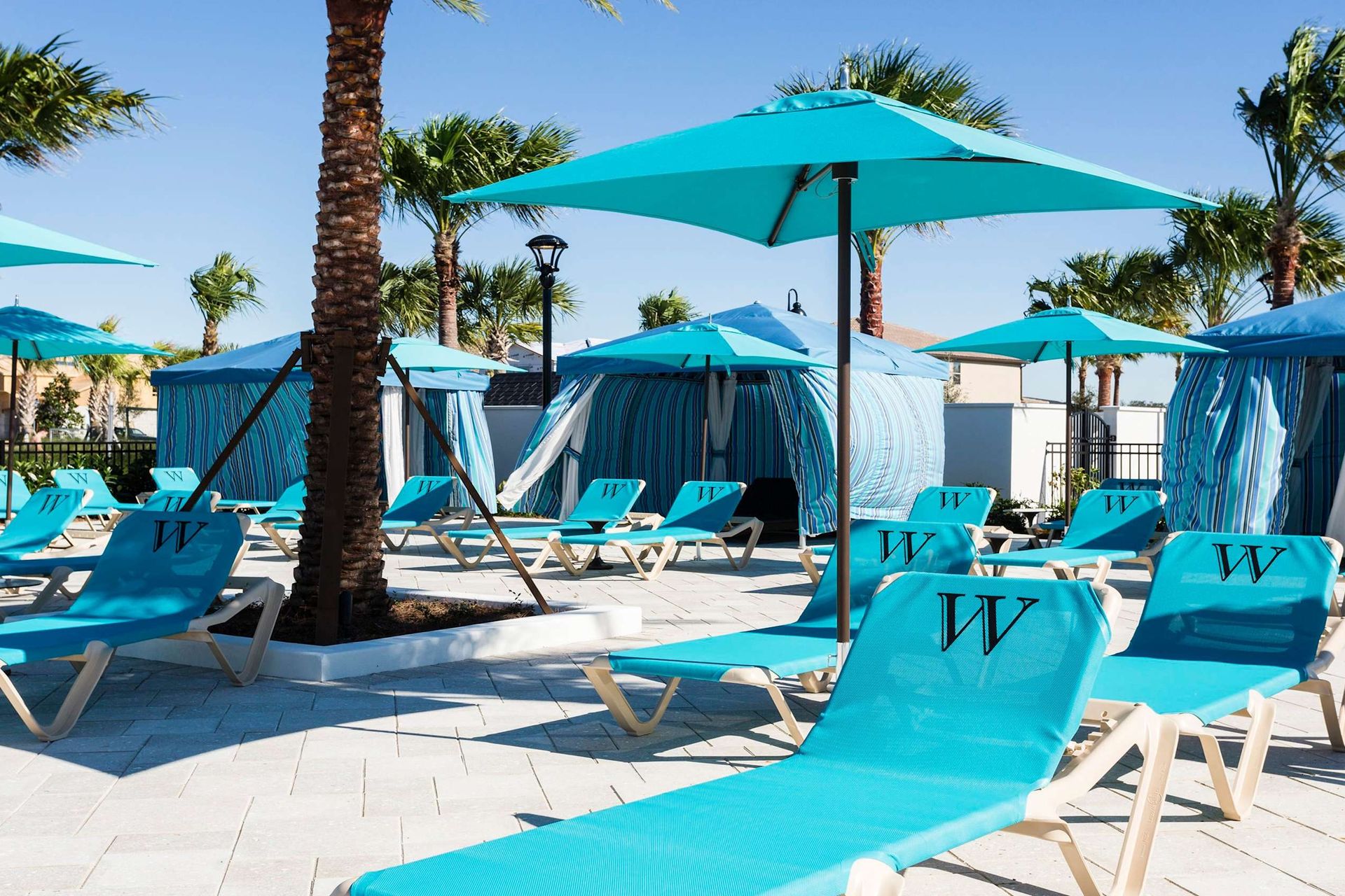 Resort Amenities - Soak up the sun in comfort on our poolside chairs, offering you a relaxing spot to unwind and enjoy the poolside ambiance.