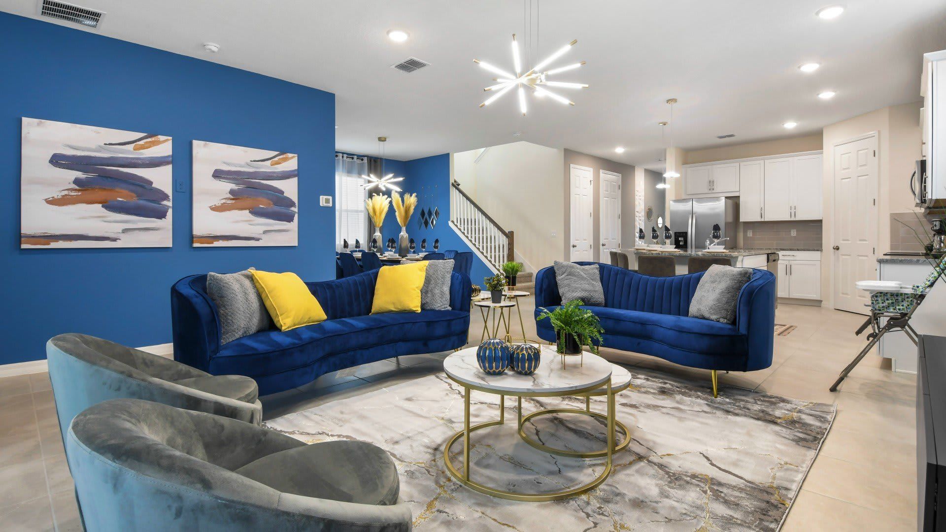 Luxurious modern home with bold blue accents, open layout, and stylish decor!