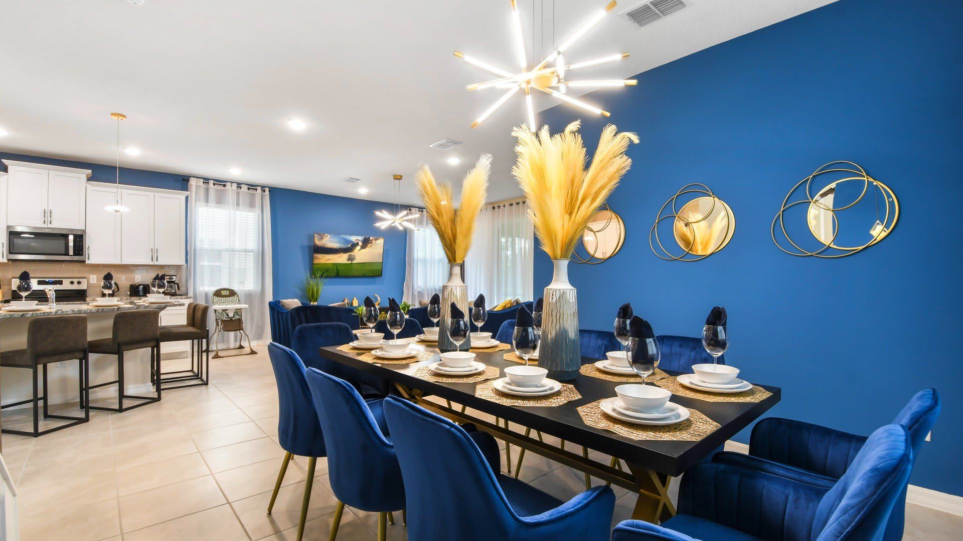 Stylish dining space with bold blue tones, gold accents, and modern elegance!